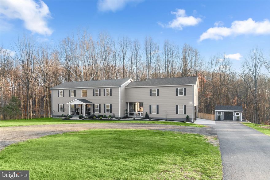 This remarkably renovated home is tucked away on a sprawling 3.05 acres, offering privacy and tranquility. Thoughtfully redesigned with no expense spared, it features a potential guest home or fifth bedroom in the generous space added above the garage, complete with a full kitchen, living area, bedroom, full bath, and storage. The possibilities are endless. The gorgeous kitchen renovation includes an oversized center island, quartz counters, decorative tile backsplash, exquisite lighting, smart stainless steel appliances, a double oven, a pantry, and a casual dining area. From the kitchen, enjoy access to a lovely breezeway and an outstanding outdoor retreat that includes a newly added deck, patio, pool, hot tub, entertainment area, and firepit. Summer barbecues will be unforgettable. Inside, the spacious family room offers the perfect place to relax, complemented by a large formal dining room ideal for gatherings and a convenient home office. A tastefully updated powder room completes the main level. Upstairs, the expansive primary suite features a sitting area, ceiling fan, and a renovated walk-in closet. The luxury primary bath is beautifully appointed with brand new flooring, separate vanities, a soaking tub, and a shower. The bedroom level also includes a laundry room with a Samsung smart washer and dryer, along with two generously sized bedrooms that offer plush carpeting, ceiling fans, walk-in closets, and an additional full bath. The impressive lower level provides a fourth bedroom, a full bath with dual shower heads, a recreation room, and an exercise room, with walkout access to the inviting patio. Enjoy swimming in the pool, roasting marshmallows at the fire pit, or relaxing in the hot tub. Additional updates include a fully fenced backyard, custom shed, breezeway, two car garage, home security cameras, washer, dryer, and an electric dog fence in the front yard. This home truly has it all.