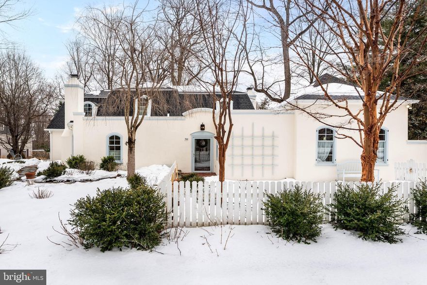 Graceful and quietly sophisticated, this French-inspired home embodies the best of Main Line living. Located in the desirable, well-established neighborhood of The Woods, its storybook curb appeal offers a warm and welcoming presence on the street. Mature gardens, picket fencing, arbors and pergolas frame professionally landscaped terraces with pea gravel and flagstone walkways throughout. A flagstone pathway leads to the home’s brick entrance. Inside, the large foyer feels gracious and inviting, conveying a sense of ease and understated elegance. Beautiful finishes, generous light and well-proportioned rooms create an interior that feels both comfortable and refined. Hardwood flooring runs throughout the home, setting a warm and cohesive tone from the entry. A powder room is conveniently tucked just off the foyer, along with a double coat closet. Gently curved doorways provide a subtle transition between rooms and reflect the home’s carefully considered design. To the left, French pocket doors open to the dining room, equally suited for intimate dinners and formal entertaining. Notable features include a striking fireplace, three sunlit windows, built-in display shelving and a door providing direct access to the kitchen. The living room evokes the feeling of a classic French home, centered around a finely detailed fireplace and framed by windows overlooking the backyard garden. Curved French double doors lead seamlessly to the gathering room with its floor to ceiling stone fireplace and wall of windows with views of the terrace, yard and whimsical playhouse. The room flows naturally into the spacious, eat-in kitchen with granite countertops and generous prep space. Glass doors open directly to the brick terrace creating an ideal setting for outdoor entertainment. A tiled- floor mudroom off the kitchen includes a coat closet, second powder room, laundry closet, rear entry from the driveway, and access to the two-car garage. One of the home’s most compelling features is the private, expansive first-floor primary suite with exceptional potential. The unfinished primary bath and walk-in closet present a rare opportunity for a new owner to create a custom retreat tailored to their own needs. Upstairs, to the right are two well-proportioned bedrooms which are connected by a renovated Jack-and-Jill bathroom with a tub. A third bedroom includes a renovated ensuite bath and adjoining sitting area or office, offering the flexibility to serve as a private guest suite or an additional primary bedroom. The partially finished basement includes utility space and storage. The property  features new Pella windows throughout, a four-zone HVAC system and newly installed shingle and flat roofs. Set in the award-winning Radnor School District and close to several prestigious private schools, this prime location offers the best of Main Line living. Minutes from the Paoli/Thorndale train stations, Wayne’s vibrant shops and dining, major commuting routes, medical facilities, universities and the King of Prussia Mall, this home is a true treasure. Private showings are available by appointment.