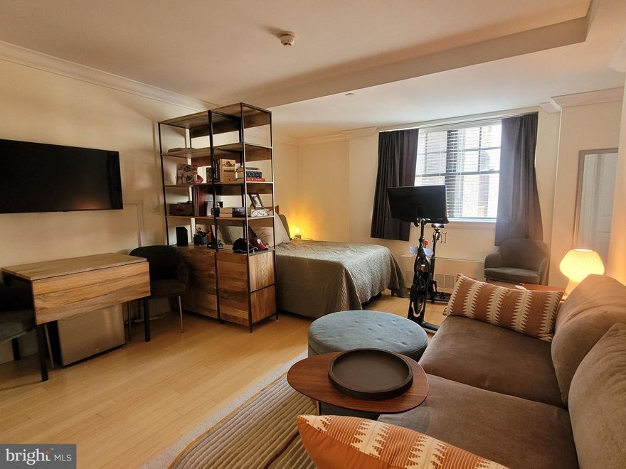 Light-filled, spacious studio at the highly coveted Warwick Condominiums. This beautifully appointed home features an open living space with an oversized window and ample space for entertaining and sleeping; an open kitchen with granite countertops and stainless steel appliances; a marble-appointed bathroom with single vanity, glass walk-in shower, and tile floor; a stacked washer/dryer; crown and baseboard molding; and light hardwood floors throughout. Residents of The Warwick enjoy the same amenities as guests of The Warwick Hotel, which is on the thirteen bottom floors of the building. Amenities include a 24-hour doorman, state-of-the-art fitness room, and for an additional fee: maid service, room service, and valet parking (subject to availability).