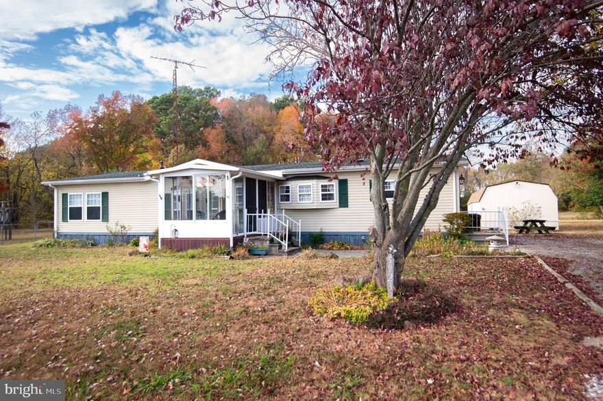 Move right in to this spacious, updated home, a practical way to enjoy life in this economy!  Fresh carpet and flooring, new light fixtures, newer upgraded appliances.  Added insulation and the  one year old architectural  grade  shingle roof assure that you will be comfortable and energy efficient. The large shed is redone and has a newer roof as well. Enjoy your enclosed front porch most of the year, and lovely country vista from the back yard while you tend to your raised garden beds.

Buyer must have proof of funds and will need to be approved by park management (application/credit report/background check required) - fee to apply.  Rules  & regs for the park are within the lease - buyer can call park manager to make application. Rent is $545/month and includes water & sewer and trash pickup. Property must be owner-occupied.