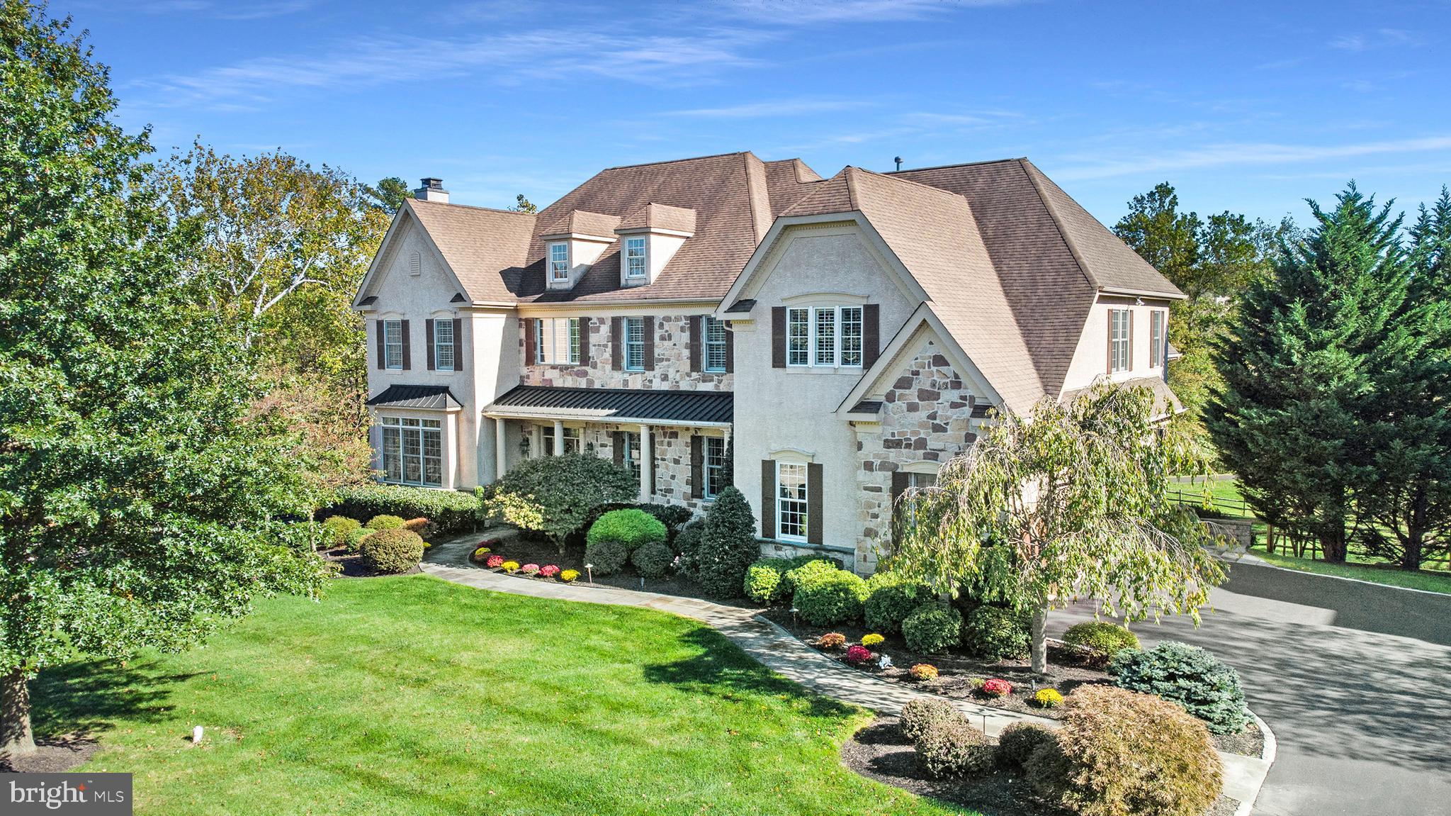 LIVING – at It’s Best. Only rarely does a property as magnificent as this appear on the market with 6 bedrooms 5 full baths, 2 powder rooms, and approximately 7,600 sf of living space. This wonderful family home sits on the "Best Premium" lot in the community with breath taking park like views. The oversized two tier composite deck is a great spot to enjoy your morning coffee or BBQ with your guests. Welcome your guests into the spacious front to back formal foyer with impressive wood staircase where you will notice the 10’ ceilings on the first floor, recessed lights, sparkling hardwood floors and beautiful woodwork throughout. There is a stunning living room with woodburning fireplace and a large formal dining room with decorative columns, adjacent to a beautiful butler pantry with granite countertop and cabinetry. The totally refurbished kitchen has white cabinetry and Carrara marble herringbone backsplash, stainless steel appliances which include a Dacor double oven, Sub-Zero refrigerator, Thermador cooktop, Bosch dishwasher, microwave and a wine/beverage refrigerator. An adjacent breakfast room opens to the two-story great room/family room with a gas burning fireplace. There is a wonderful study and a customized powder room with a beautiful vanity. The back staircase leads you up to a cozy family home study center where you will notice the 9’ ceilings on that level. Enter into the master bedroom suite with tray ceiling, a large sitting room both with brand new maple elongated hardwood floors, and his and her custom walk-in closets. The sensational new master bathroom has quartz countertops, radiant-heated tile floor, custom crystal lighting fixtures, beverage refrigerator, custom cabinetry and private commode. There are four other very spacious bedrooms with 3 full bathrooms. The finished daylight and walk out lower level has modern laminate tile-like waterproof flooring, and recessed lights. This could be a perfect nanny suite/ in-law suite or just for you and your family to entertain with friends. It includes a second family room, with a spacious kitchenette with an expanded granite bar, pantry, full-size refrigerator, dishwasher and microwave. The spacious 6th bedroom has a full ceramic tile bath, and double sized windows. There is an additional large room that can be used as a media/home theatre room. The customized laundry room, mudroom, back hall powder room, 3 car garage, and 2x6 construction, completes this lovely property. Other added upgrades, are a 3 zone HVAC system which includes a three year old central air units, two hot water heaters, and three circuit breaker boxes. If you are looking to stay fit head outside and enjoy the community walking trail located in a very peaceful parklike setting which leads you to Starbucks, Whole Foods, and great restaurants. This home includes the Smart Home System (Comcast) which includes the Nest thermostats and Lutron lighting switches. The house has Plantation shutters, and so much more!