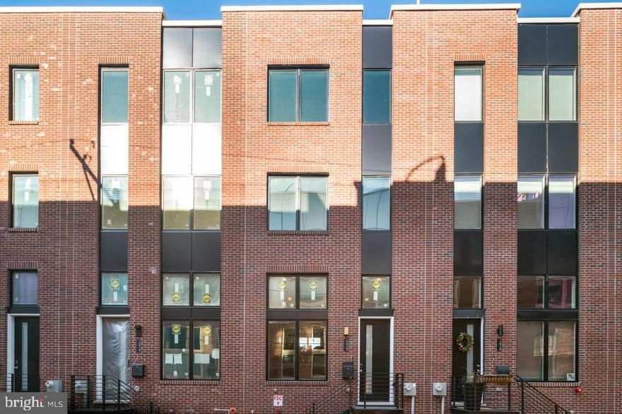 Welcome to 1312 S Woodstock St – Luxury Living in Wharton Court, Point Breeze, Built in 2022 and nestled on a quiet cobblestone street, this stunning 3-bedroom, 2 full and 2 half bath townhome is part of the exclusive Wharton Court development in the heart of Point Breeze. It offers a perfect blend of modern sophistication and timeless charm. Step inside to soaring 14-foot ceilings and a sun-filled open layout that defines the main living area. The contemporary kitchen features GE Profile stainless steel appliances, a spacious design, and overlooks the living room with glass railings for an airy, seamless flow. The owner’s suite spans an entire floor, showcasing a luxurious spa-style bathroom with a soaking tub, oversized shower, and a massive walk-in closet. Upstairs, two additional bright bedrooms, a laundry closet, and a dry bar lead to the private rooftop deck with breathtaking views of the Philadelphia skyline—ideal for relaxing or entertaining. Additional features include a finished basement and a private garage with direct home access for added ease and security. Smart home technology includes Google Nest thermostats, Nest smart lock, video doorbell, and a garage security camera—all manageable from your phone or tablet. Ideally located just minutes from Center City, University City, CHOP, and I-76, this home delivers luxury, comfort, and convenience in one of Philadelphia’s most dynamic neighborhoods. Schedule your showing today! First month’s rent, last month’s rent, and a one-month security deposit.