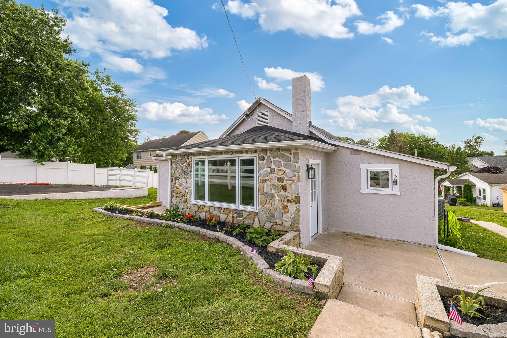 Clean lines, natural light, and thoughtful design define this fully rebuilt home in the heart of Collegeville. Every major system has been replaced—plumbing, electrical, HVAC, and a new private well, offering rare water independence in an area where most homes rely on shared sources. The lower level has been professionally waterproofed with a full French drain system, adding long-term protection beneath the surface. The layout includes 4 bedrooms and 3 full bathrooms, with a finished lower level, its own entrance, and a newly added bath. The kitchen is all new, featuring custom cabinetry, quartz counters, modern appliances, and a soft backsplash that adds warmth and texture. Throughout the home, a calming palette of sage and neutral tones creates a natural, airy feel that brings the outside in. A new Trex deck connects to an Oldcastle Rio Blend Stone-style patio, perfect for laid-back mornings or easy entertaining. Located in the Methacton School District near Arrowhead Elementary, trails, and local favorites, 15 Henry Ave blends quality, style, and comfort in one beautifully redesigned space.