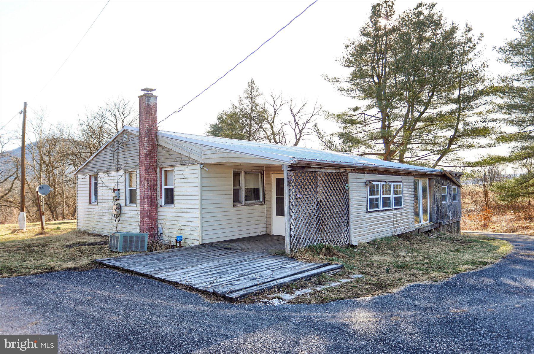 ATTENTION INVESTORS AND AMBITIOUS BUYERS! Secluded Acres with Potential in Newport! Here's your chance to own 5 private acres just outside Newport. This property includes a 3-bedroom ranch home ready for a complete renovation or could be the perfect spot to build your dream home. Living room, kitchen, full sunroom addition and workshop area.
The existing house needs a full makeover due to its rough condition and water damage from a broken pipe. This could be a great project for someone looking to create their own custom home. Or, with 5 acres, you have plenty of space to build exactly what you want and enjoy a peaceful, private setting. This would make the perfect homestead location tucked back in a dead end bordering Newport Fairgrounds. Seclusion and privacy as the fair is 1 week a year! Schedule a tour and see the secluded setting!