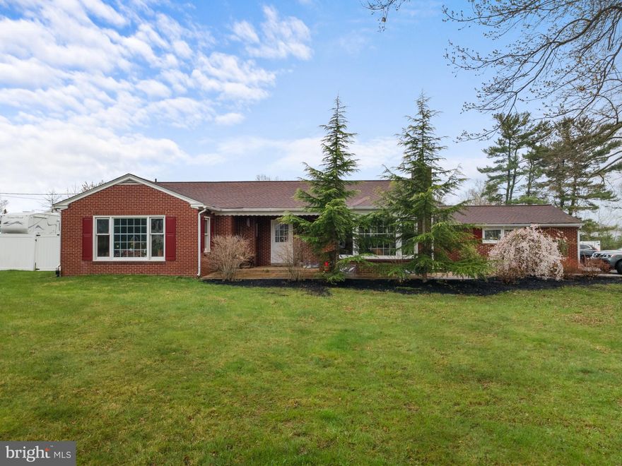 Calling all growing families or growing businesses! Welcome to 3309 Unionville Pike in Hatfield, the rare ranch property where you can have one level living with room to grow in a truly unique setting! The property has over an acre of land, a massive fenced back yard and is Zoned LI (light industrial), so it could be used for your home based business OR sold along with 3247 Unionville Pike for a business owner who wants to occupy one home and run a business out of the other home, additionally it could be an amazing rental income producing opportunity. As you enter 3309 Unionville you will see a stamped concrete sidewalk that leads you into the foyer dutch door and hardwood floors. To your right is your massive family room with fireplace and wood burning insert and hardwood floors. Behind the family room is a large office space featuring hardwood flooring, views of the back yard and access to the two car garage area (more about that later). Just to the left of the office is a very large, eat-in kitchen with a center island, tons of cabinet space and views of your entire back yard and paver patio! Off of the kitchen is one of the larger back bedrooms with hardwood floors, a ceiling fan and great views out to the patio. In the hall you will find a full bath with shower stall, tile floor and a smart toilet (yes it’s pretty smart for sure) with automatic lid and bidet feature. Heading down the hall you will find a second back bedroom with hardwood floors, a terrific back yard view and a ceiling fan too! This home has larger closets for extra storage space and pull down stairs for attic storage as well. There is a second full bath with a jetted tub shower, tile floors and another smart toilet! And winding out the main level there is a large, bright and light 3rd bedroom with views out front, hardwood floors and a ceiling fan. Heading downstairs, you can access the basement from the garage or the kitchen. You will find that the basement has been divided into multiple rooms that could be remodeled or the walls could be removed to open this up to a much larger space. The basement has a full bathroom plus you will find the well cap, well pump, radon remediation system, water softener and water filtration system. One of the rooms in the basement has a pellet stove insert too for an additional source of heat. There is a washer and dryer in the basement, but also a second washer and dryer in the garage area too (all are working). The heating system has been converted from oil to electric, but the oil tank and boiler are still there should you wish to use oil. Heading up the basement stairs to the garage you will find the second washer and dryer in this space as it was used for a craft room and main level laundry room. There is a separate mini split heating system in this space. The temporary wall could be removed in this space to turn it back into a garage again. This home has tons of parking with easily 8+ parking spaces and inside the fenced back yard is a wonderful and large paver patio with a fire pit  for entertaining family and friends! This level, fenced back yard is ready for you to make it your own whether its adding a pool or garden and more and is ideal for a growing family and for pets too! This is a one of a kind property with access to Rt 309, Lansdale, Montgomeryville, Ambler and the PA Turnpike. Home is being sold AS IS no credits or repairs by seller.