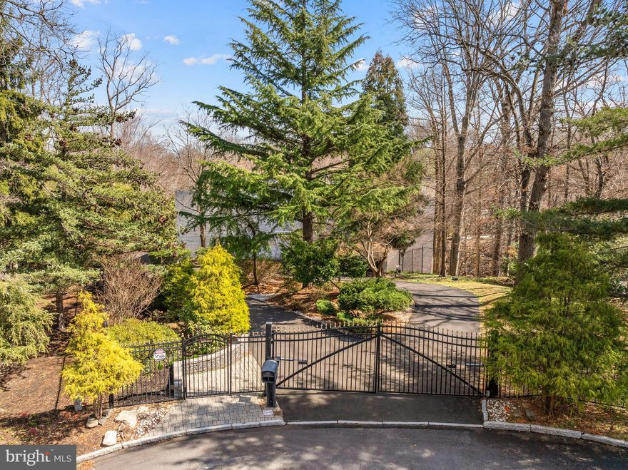 Tucked away on almost an acre at the end of a quiet cul-de-sac, this architecturally stunning custom contemporary home seamlessly blends views of nature on its interior, while the outdoor spaces create a retreat in the tree tops.

Step through the double doors into a foyer adorned with imported marble tile, setting the stage for a home that exudes elegance and modern sophistication. The recently updated gourmet kitchen features quartz countertops, a stylish backsplash, ceramic tile flooring, and high-end European Forte stainless steel appliances. The seated island accommodates four and is the perfect setting for cooking with family or entertaining. Adjacent to the kitchen, a bright and sunny breakfast area flows into a four-season room, offering a perfect space to enjoy natural light year-round. The adjacent family room creates great flow for everyday living and offers flexible living space. 

The heart of the home is the breathtaking two-story great room, where 30-foot ceilings and a wall of windows flood the space with natural light. A wood-burning fireplace with a floor-to-ceiling stone surround adds warmth and ambiance, making this an inviting area for relaxation and entertaining. Beyond is a living room with a bar area and access to the expansive deck. Step outside to the 1,800 sqft composite multi-level deck and pavilion, an incredible outdoor sanctuary perfect for entertaining or quiet enjoyment. A spiral staircase from the great room leads you to a versatile loft space, ideal for a private office or recreational area.

On the second floor, the luxurious primary suite boasts a renovated marble-tiled bath,complete with soaking tub, frameless glass shower and double vanity, in addition to dual walk-in closets, and a private balcony. Four additional spacious bedrooms and a hall bathroom, an ensuite bedroom and bath, and a laundry room complete the upper level.

The finished lower level offers even more flexible living space, including a second recreation area, a bedroom/office room , and a full bath. Located in the award-winning Lower Merion School District, this home provides easy access to major highways, as well as top-tier dining, shopping, and recreational amenities. *Some of the photos have been virtually staged*