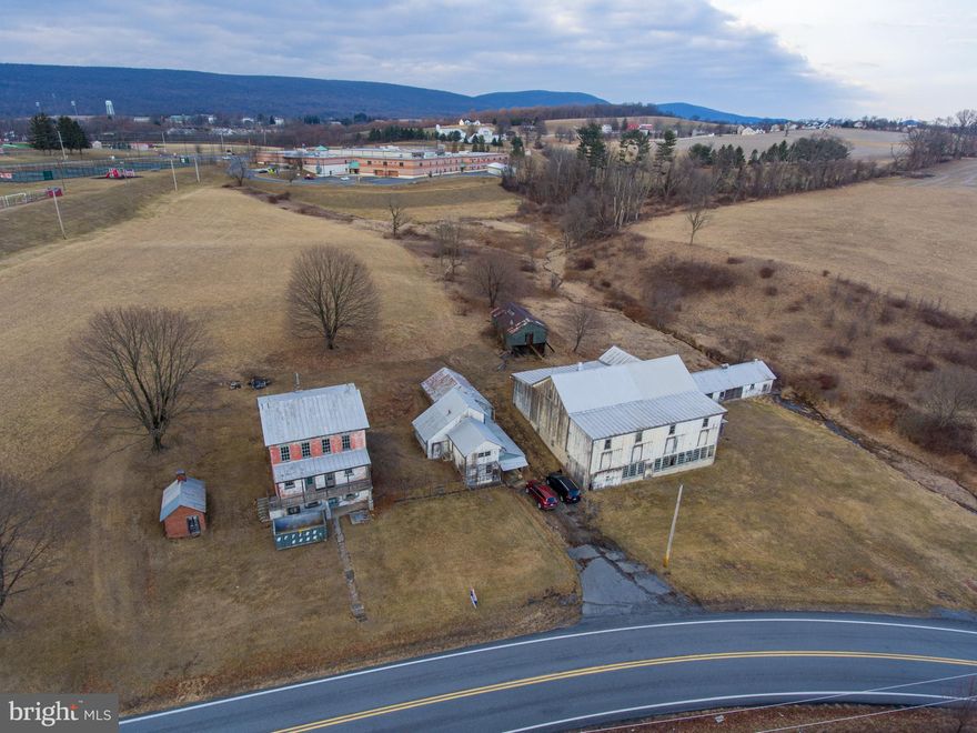 This property is being offered for sale at auction on Thursday, April 17, 2025 at 3:00 PM. List price is the suggested opening bid only and is not indicative of the final sale price. Open House: Saturday, March 29, April 5 & 12 (1-3 pm.) or by appt. Terms: 10% down day of sale; settlement within 45 days of sale.

REAL ESTATE:  32.88 ACRE FARM w/3 sty. brick farmhouse containing approx. 2,400 SF of living area. Ground level includes an eat in kitchen/living room and utility room. Main level has a foyer, 3 bedrooms and a full bath. Third level includes another kitchen, 4 bedrooms, and a full bath. The home has a full attic, 9’ ceilings, a covered front porch, coal fired hot air furnace and on site well and septic. OUTBUILDINGS: 62 x 60 stone & frame bank barn w/addition & attached 21 x 80 chicken house; 23 x 30 two-story former milkhouse w/water & electric & attached 34 x 20 garage; 10 x 15 brick smokehouse. LAND: Approximately 24 acres of tillable land with approx. 1935’ road frontage.

28.07 ACRES OPEN LAND in Windsor Township and Hamburg Boro with approx. 20 acres tillable ground and 1,300’ road frontage, zoned Ag and Medium Density Residential, with subdivision possibilities. Sold separately from farm.

NOTE:  This quiet and peaceful farm has been in the Merkel family since the mid 1800’s and this is the first opportunity for purchase. The farm offers plenty of opportunity, zoned agricultural, bordering Hamburg Boro and within minutes of downtown Hamburg with easy access to Rts. 61, 78 and Old Rt. 22. This farm and land is in Clean and Green but not in Ag Preservation. The buildings are in need of repair, offering opportunity for renovations.