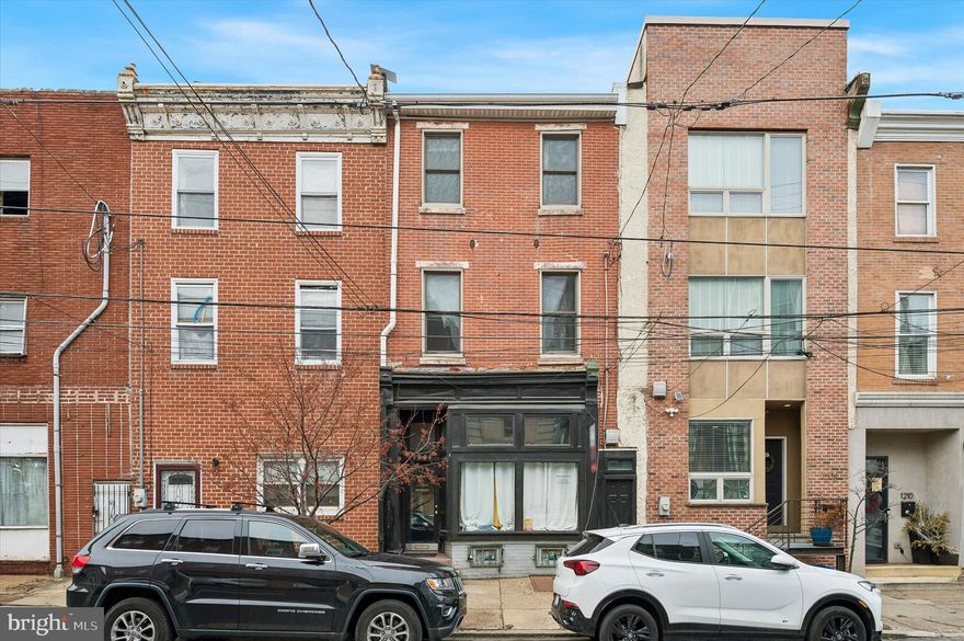 1206 N 5th Street is a fully occupied, income-producing 4-unit mixed-use building in the heart of the thriving Northern Liberties/Olde Kensington corridor, featuring 1 commercial storefront, 1 studio apartment, and 2 one-bedroom units, plus a shared outdoor space and basement with common laundry. All utilities are separately metered, except water and those powering the laundry, helping to control operating expenses. The property offers a strong 9% cap rate, so you generate income on day one. All leases are currently month-to-month, providing flexibility to renovate and increase rents as units turn over or to pursue owner-occupancy if desired. The residential units offer enormous ceilings and excellent natural light, and the commercial space features a traditional storefront façade without the burden of a historical designation. Lead-Safe Certificates for all three residential units, Rental License, Fire Alarm Certificate, and leases will be provided upon successful offer for the Buyer’s review. Located just steps from Girard Avenue and a few blocks from the shops and restaurants at the Piazza and along Frankford Avenue and Front Street. Convenient access to the Market-Frankford Line for an easy commute to Center City and beyond, this high-visibility location continues to attract entrepreneurs and renters alike, making it an exceptional opportunity for investors seeking immediate cash flow with long-term upside. Unit breakdown: 1st Floor Commercial Unit $700/mo (M2M); 1st Floor Rear Studio $995/mo (M2M); 2nd Floor One Bedroom $1200 (M2M); 3rd Floor One Bedroom $1437 (thru 6/30/2026).