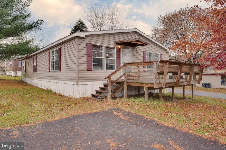 Very well kept, open concept home ready for its new owners! Enter this home from the large deck with bench seating into the large living area with tons of natural light throughout. Brand new carpets throughout. All appliances remain including the washer and dryer in the convenient mudroom with outside access. This home has a primary bedroom with great closet space, and a large bathroom with soaking tub and standing shower. There are also two additional bedrooms, and a newly replaced side porch. The lot rent includes water, sewer, and trash. Great property in Blue Mountain schools ready for its new owner!