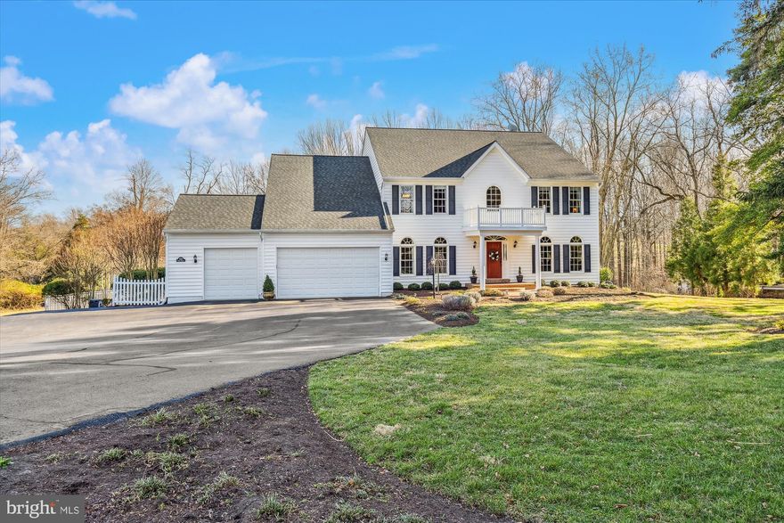 Nestled on 4.58 acres of gently sloping land, this stunning stately Colonial-style residence offers the epitome of luxury and privacy, and desirable living spaces. With a 3-car garage and extra-large driveway accommodating over 10 vehicles, hosting gatherings is easy. The dramatic two-story foyer and family room boast cathedral ceilings. Arched windows flood the spacious living and dining areas with natural light, while recessed lighting adds to the ambiance. The living room offers generous space and includes Bose surround sound speakers, is large enough for seating plus a baby grand piano. LR has a large opening to the foyer, creating great flow for meal time. The light-filled separate dining room showcases contemporary chandelier, wall sconce lighting, and is complemented with large crown molding and a butler’s pantry. The kitchen features rich wood cabinetry, under cabinet lights, gas cooktop, instant hot water, stone backsplash, wall oven, built-in microwave, kitchen pantry and a peninsula w/ breakfast bar seating. The main level has laundry, a mud room, and a nice sized powder room. The owner's suite has a sitting area, walk-in closet, and an en suite bath with a soaking tub, a separate roomy ceramic tiled shower, and double sink vanity. Main level has an additional bedroom, perfect for a home office. Even more highlights include 4BRs upstairs, including a second suite. An upper level catwalk separates the bedrooms (2 on each side) plus 2 full baths, one part of a suite. The walk-out lower level offers good natural light, a den and gaming area, a kitchenette, plus sliders to the private rear yard that backs to the woods. The 7th bedroom on this level is perfect for guests with the 4th full bath next to it. There's a beautiful three season sunroom with ceiling fan lighting, wall of windows on three sides & beadboard ceiling. The sunroom overlooks and connects to the expansive backyard and deck. The deck is perfect for grilling, enjoying the sun, or bird watching. The property also features an in-ground salt-water swimming pool that is absolutely lovely, plus a beautifully designed stone retaining wall which creates an entertaining area, with grill hook-up, and raised flower beds. The concrete deck offers ample room for multiple seating areas. This home boasts a highly coveted GEOTHERMAL HVAC system. It is both green and exceptionally economical in heating and cooling (low utility bills). This is a wonderful home perfect for luxury living and excellent for entertaining. This home with over 6,000 sq feet on 3 levels on expansive land, is one of a kind.