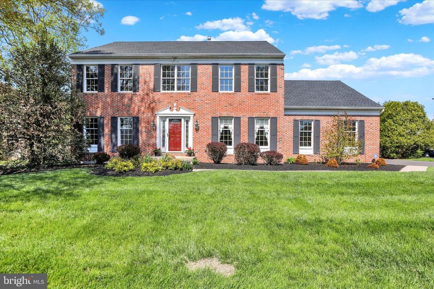 Welcome to this elegant Haverford model by Toll Brothers, a beautifully upgraded residence showcasing a timeless brick façade and a spacious two-car side-entry garage complete with wall storage and remote keypad access. Ideally situated in the highly sought-after Cold Spring Hunt community within the award-winning Central Bucks School District, this home offers exceptional craftsmanship, thoughtful updates, and a prime location. A custom walkway framed by professional landscaping leads to an inviting front entrance, where a dramatic two-story foyer welcomes you with hardwood flooring, a turned staircase with oak railings and refinished wood treads with white risers, a custom electric upper window blind, and elegant millwork including crown, chair rail, and decorative moldings. The formal living room features dentil moldings, custom drapery, newer carpeting, and French doors that open seamlessly to the family room, while the formal dining room is equally refined with hardwood flooring, crown and dentil moldings, chair rail, and wainscoting, along with convenient access to a dry bar with recessed lighting. The gourmet kitchen is thoughtfully designed with granite countertops, an undermount double sink, a custom travertine tile backsplash, recessed lighting, and Omega solid cherry cabinetry with under-cabinet lighting and soft-close drawers. A spacious center island with granite overhang seating for four and pendant lighting anchors the space, complemented by stainless steel appliances including a KitchenAid refrigerator and double wall oven, GE Profile electric cooktop, a Miele dishwasher, and a built-in GE microwave. The adjoining breakfast room features a newer sliding glass door leading to an expansive deck with scenic backyard views, ideal for outdoor dining and relaxation, while a generous walk-in pantry adds both function and storage. The family room offers a warm and inviting atmosphere centered around a brick gas fireplace with raised hearth and wood mantel, and the main-level laundry room provides additional convenience with ample cabinetry, closet storage, and direct access to the deck. A private office with double windows and crown molding completes the main level. Upstairs, double doors open to a luxurious owner’s suite featuring a tray ceiling, new carpeting, ceiling fan, linen closet, and a custom walk-in closet. The spa-inspired en-suite bath includes a seamless glass walk-in shower with ceramic tile and mosaic accents, a dual vanity with Corian countertops, a skylight with a Velux electric blind, and a soaking garden tub. Three additional bedrooms, each with carpeting and ceiling fans, are served by a beautifully renovated full hall bath with dual vanity and ceramic tile finishes. The finished lower level provides exceptional additional living space, including a spacious recreation or media area with new carpeting, recessed lighting, built-in cabinetry, and shelving, along with a dedicated hobby or workspace featuring custom built-ins and a desk area. Recent improvements include a newer roof, gutters, and downspouts (2023), HVAC system (2022), and hot water heater (2022), ensuring peace of mind for years to come. Ideally located near Cold Spring Elementary School and Hansel Park, as well as Peace Valley Park and Holicong Park, this home also offers convenient access to the vibrant downtowns of Doylestown and New Hope, along with the SEPTA Regional Rail for easy commuting to Philadelphia and many adjacent suburbs. This location is also commutable to New York City, The Pocanos and all New Jerasey Shore points. This exceptional residence offers a seamless blend of luxury, comfort, and location, creating a truly distinguished place to call home.