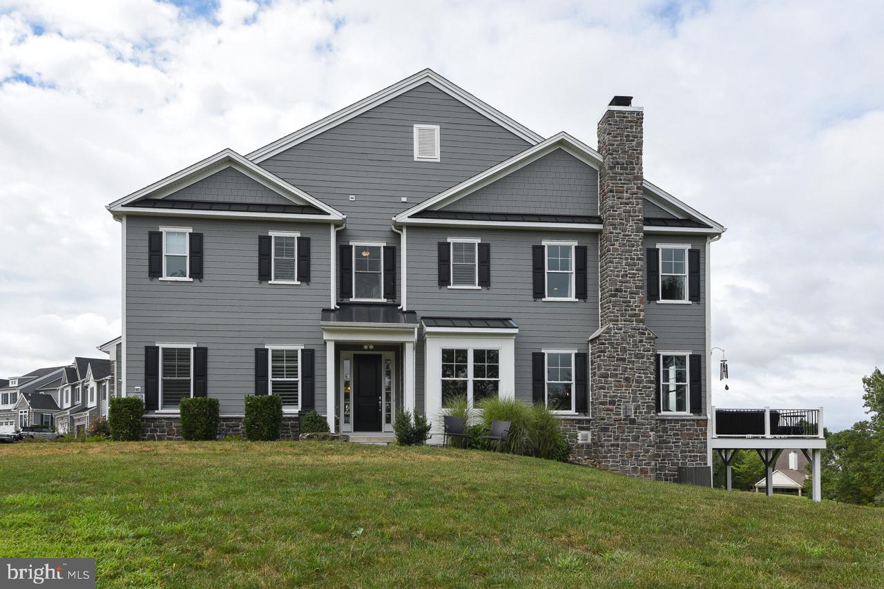 Nestled in the prestigious Preserve at Burke Farm in Doylestown Township and served by the award- winning Central Bucks School District, this impeccably maintained carriage home blends luxury, comfort, and timeless style. A charming covered entry welcomes you into the foyer, opening into a bright and airy living space with soaring 9-foot ceilings throughout. Just off the foyer, French doors reveal a private office with crown molding and plantation shutters—perfect for remote work or a quiet retreat. The formal dining area shines with a striking chandelier, crown molding, and a cozy window nook. At the heart of the home lies the chef’s dream kitchen, featuring a grand 10-foot center island with granite countertops and pendant lighting, 42” cabinetry with under-cabinet lighting, a built-in wall oven and microwave, a 5-burner gas cooktop, under-mount sink, walk-in pantry, and abundant storage and prep space. Seamlessly connected to the kitchen, the inviting family room showcases crown molding, a beautiful gas fireplace, and French doors opening to a spacious deck with a BBQ grill conveniently connected directly to a gas line—perfect for quiet evenings or lively gatherings. A stylish powder room and access to the two-car garage with a custom slat-wall organization system complete this level. Upstairs, also with 9-foot ceilings, awaits the luxurious primary suite, entered through double doors. This retreat features a tray ceiling, ceiling fan, sitting room with recessed lighting, and a walk-in closet with built-in cabinetry. The spa-inspired bath boasts a double vanity, oversized tiled shower, private water closet, linen closet, and plantation shutters. The second floor also includes two additional bedrooms—each with a ceiling fan, walk-in or double closet, and its own private ensuite bath (one with a tiled tub/shower, the other with a tiled stall shower). A convenient laundry room with custom cabinetry, sink, and built-in ironing board complete this level. The wide wood staircase leads to the expansive lower level, offering a large unfinished area with windows and sliding glass doors to the yard, this versatile space is ready for storage, recreation, or additional living space. Unbeatable location with convenient access to Routes 202, 309, and 611. Just minutes to Doylestown’s vibrant borough with its charming shops, dining, and museums. Also with direct access to the 202 Parkway Trail, seamlessly connecting bike paths throughout Bucks and Montgomery Counties. This remarkable home offers a rare opportunity to enjoy a lifestyle where elegance, convenience, and comfort converge.