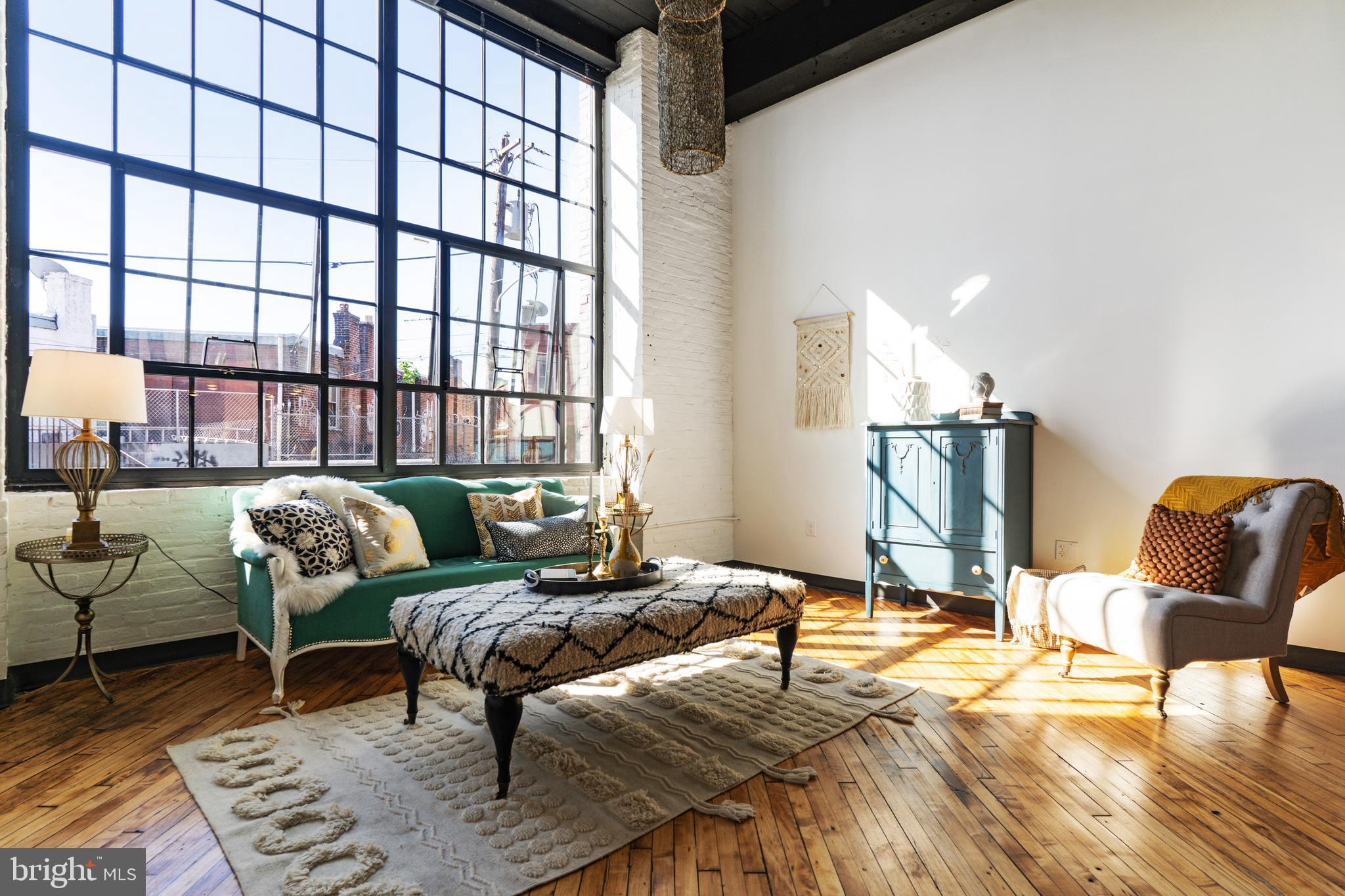 Check out this beautiful industrial style studio apartment with stairs to a lofted bedroom. Advertised Rent is for a 15mo lease. The sky high ceiling and enormous wall of windows fill with light and class. Our favorite things are the updated cook's kitchen with stainless steel appliances and handy counter and cabinet space. You'll love how the kitchen counter nook opens into the living area, perfect for a couple stools. Design wizards will love the original hardwood floors and open ceilings. A shared laundry room is right down the hall. J-Centrel is a renovated textile factory located in a re-energized section of Kensington and Harrowgate along the Market-Frankford El corridor one block from the Tioga El Station. Amenities include tenant lounges, fitness center, mail room, bike room and keyless entry. Responsive landlord and maintenance team. Tenants pay electricity, cable, and renter's insurance (apartment is all electric). $50 Application/credit check. Security deposit, 1st and last month's rent moves you in. We can't wait to show you this apartment.
