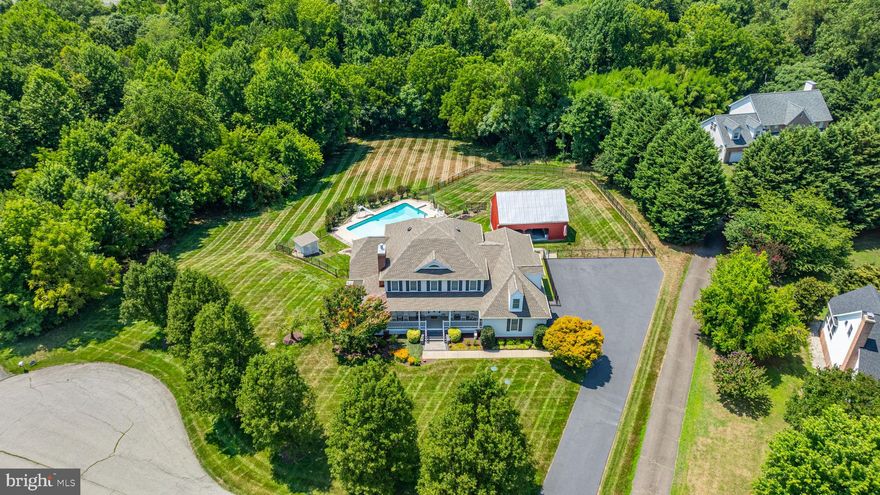 Welcome to 8920 Bayou Court, a meticulously and completely renovated property designed for luxurious living and modern convenience. This is not just a house; it's a lifestyle, offering unparalleled comfort, style, and convenience. Where every detail has been thoughtfully considered to create an oasis of elegance. 
Inside, all six bathrooms have been modernized with new sinks, granite counters, faucets, and showers or tubs, including custom-tiled doors in the primary and first-floor guest showers. The main level primary suite boasts an expanded shower and water closet with ceramic flooring, an extra closet, a built-in dresser, and a remote-controlled propane fireplace. Imagine unwinding in these luxurious spaces after a long day, surrounded by the finest finishes. Living areas feature a wood-burning fireplace in the living room and propane fireplaces in the living room, primary bedroom, and basement, creating a warm and inviting ambiance throughout the home. New hickory prefinished hardwood floors grace the dining, living, foyer, family room, and primary bedroom, while the basement gym room is carpeted for comfort. The kitchen has been fully updated with new appliances, including a propane cooktop, quartzite counters, a new sink with instant hot water, under-cabinet lighting, and amazing expanded pantries with pull-out shelves. Every culinary enthusiast's dream, this kitchen is perfect for creating gourmet meals and entertaining guests. There’s also a rare second bedroom and full bath on the main level.  
A new 12’x22’ all-season room, with access to the guest room deck and the rear yard pool, offers the perfect retreat to enjoy the changing seasons. This space is ideal for morning coffee or evening gatherings, offering a seamless blend of indoor and outdoor living.
The garage is a showstopper, featuring replaced doors and motors with WiFi connectivity, a carpeted and painted floor, and minisplits for air conditioning. This is more than just a garage; it's a pristine space that any car enthusiast would envy.
The exterior features include a beautifully repaired and painted barn for an undercover entertainment area. The pool area is enclosed with elegant aluminum fencing, and the landscaping has been refreshed with an irrigation system. Aluminum fencing surrounds the backyard, offering both security and beauty. The rear walkways have been upgraded with pavers, and the front wrap-around porch and guest decking are new. The driveway has been completely rebuilt with a new base and asphalt, lengthened and widened for additional parking. This outdoor haven is perfect for hosting summer parties or simply relaxing in the tranquility of your own private paradise.
Not only was the house updated visually, but it was also renovated structurally and mechanically as well. New roof shingles and all gutters, including those on the barn, have been upgraded to 6 inches. The well tank, pressure pump, and well have been replaced for optimal performance. Electrical updates throughout the home include LED lights and fans. Both HVAC systems have been replaced with new heat pumps, an attic air handler, a propane backup furnace, and a basement unit. A Nivian Propane tankless hot water system and a 30KW Kohler generator with a 500-gallon propane tank have been installed to ensure uninterrupted comfort. The basement includes an automatic dehumidifier, and all windows have been replaced for enhanced energy efficiency. Pool enthusiasts will appreciate the new equipment, including a filter, salt cell, Polaris cleaner, pressure gauge, and updated pool shed doors. 
Entertainment upgrades include an electric Mantel Mount for the family room TV and an 85” TV in the basement entertainment room. Hunter Douglas automated window treatments with remotes add a final touch of modern luxury.
Experience the exceptional craftsmanship and thoughtful updates that make 8920 Bayou Court a truly remarkable place to call home. Schedule your visit today and start living