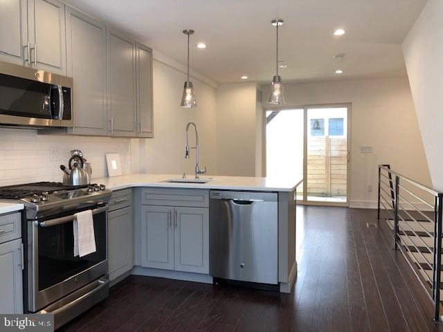 Gorgeous new construction and affordable condo situated on a quiet, small street in the booming West Poplar neighborhood! Just a block and a half above Springgarden Street, enjoy a peaceful walk along the Rail Park or pop in Prohibition Taproom or enjoy the vibrant outdoor dining at Juno! There is plenty to do in this blossoming neighborhood! Equipped with a FULL 10 Year Tax Abatement and a 1 year builder's warranty to save your bottom line and give you peace of mind. Entering into this condo you are immediately greeted by a bright, modern kitchen with gray cabinetry and white quartz countertops. The illuminated kitchen contrasts perfectly with the dark hardwood floors that extend through the living room and peer out the large glass slider into the private back patio. Plenty of outdoor space for entertaining! Heading downstairs a level will lead you to an extra large bedroom and contemporary gray-tiled full bathroom with white a white vanity and chrome finishes. Loads of closet space and storage along with an in-condo washer and dryer right outside the bedroom for ease of use! Set up your private tour today! **CONDO FEES AND TAXES ARE ESTIMATES**