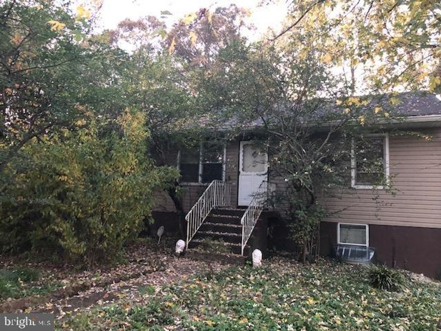 This property is a Gem in the rough! It does need some cosmetic work but it is well worth seeing. Located at the end of a quiet street and settled among the trees, serenity lives here. Agents bring your clients with vision and who want a great deal. Vacant and on lockbox but call our office before showing.