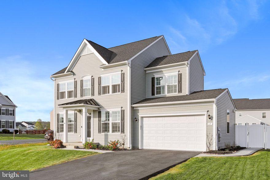 Pride of ownership really shines through in this gorgeous colonial on a corner lot.  The main level features all hardwood flooring throughout.  There is a formal dining room, kitchen, living room and half bath on this level. The gourmet kitchen features oversize island with breakfast bar, stunning white cabinetry, and beautiful custom tile backsplash.  The kitchen is bright and awash with natural light. The appliances are stainless steel and the countertops are quartz.  The view to the back yard from the kitchen area is the stamped patio surrounded by the maintenance free white vinyl privacy fence.  Upstairs is the owner's retreat with tray ceiling, two walk in closets, and a stunning bath with separate large shower and soaking tub.  There are three additional large bedrooms on the upper level; each with their own walk-in closet.  The upper level has another full bath with double sink and laundry closet.
The lower level features a den/office/media room with closet, recreation/family room with access to the walk out stairs, full bath, plus a storage/mechanicals room.  The basement has another laundry hook up. 
 Minutes from I81 and Winchester, Martinsburg areas.