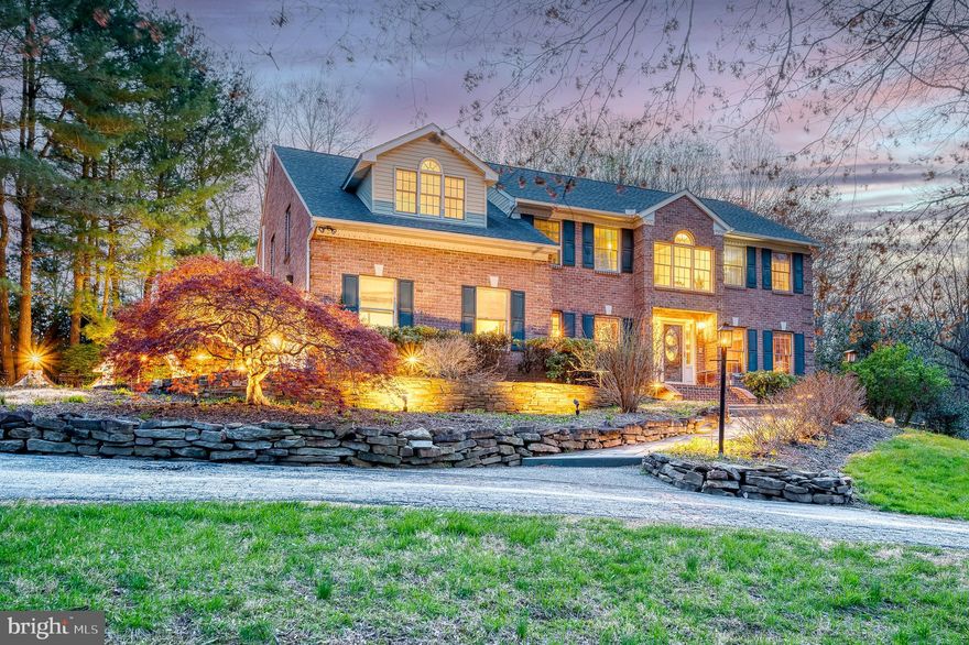 Welcome to 1104 Lower Glencoe Road – a one-of-a-kind custom home nestled on 3.76 private acres in desirable Sparks and the coveted Hereford Zone school district. From the moment you arrive, the charm begins: a circular driveway, sideload garage, ample parking, and a spacious shed offer functionality and curb appeal. Step inside to a two-story foyer that sets the tone for the elegance throughout. Entertain in style with a formal living room featuring hardwood floors and crown molding, and a dining room with both crown and chair rail molding. The heart of the home is the eat-in kitchen with stainless steel appliances, a gas cooktop, and direct access to the main-level laundry/mudroom with private entrance. The sunken two-story family room has a cathedral ceiling, a cozy fireplace, wet bar, and two exits leading to your outdoor oasis—a stunning retreat featuring a large patio, retaining wall, inground pool, and even a vegetable garden ready for your green thumb. Upstairs, you’ll find generously sized bedrooms with hardwood floors and ample closet space. The luxurious primary suite offers a sitting room, two walk-in closets, and a spa-like bath with a jetted tub, separate shower, and skylight for added ambiance. The fully finished lower level adds incredible versatility with a spacious rec room, bonus room with walk-in closet, and a full bath—ideal for guests, a home gym, or office. Additional highlights include dual-zone HVAC, two 200-amp electric panels, central vacuum, updated well/septic and water heater, gutter guards, and pre-wiring for an alarm system. This property combines privacy, comfort, and elegance. New roof - 2017; New septic - 2019.