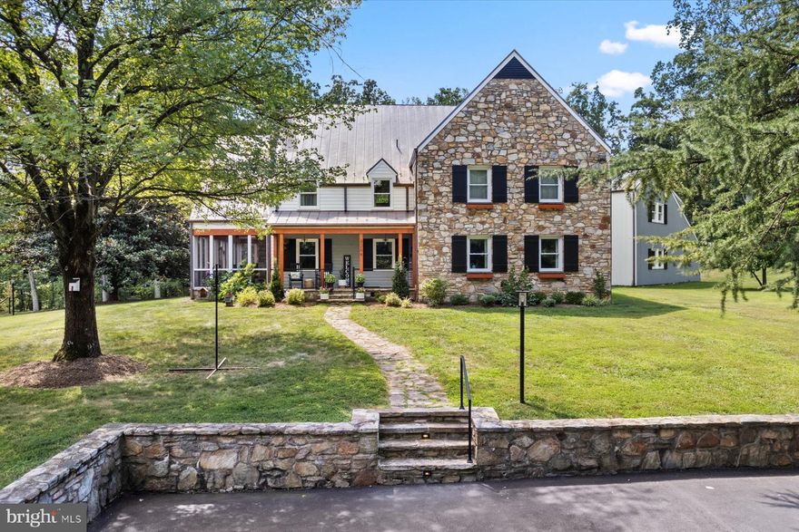 Rarely does a property of such quiet distinction come to market. Spanning more than 36 acres across three combined lots and backing to protected land, this remarkable estate offers a rare sense of seclusion—just minutes from the heart of Haymarket.

The five-bedroom farmhouse is a thoughtful blend of historic charm and modern refinement. Sunlight fills the interiors, where exposed wood beams add warmth and character. The chef’s kitchen, appointed with soapstone countertops and a professional-grade gas range, is equally suited for intimate gatherings or larger-scale entertaining. A stunning wraparound porch—partially enclosed and anchored by a fireplace—extends the living space outdoors, overlooking sweeping lawns, mature trees, and a serene pool and spa set against the backdrop of the Bull Run Mountains.

Every detail has been carefully considered. Recent enhancements include wide-plank hardwood flooring throughout, a reimagined primary suite, updated secondary baths, and a refined laundry and mudroom. Significant exterior and systems upgrades include a new copper roof, gutters and downspouts, cedar siding, a paved driveway, hand-laid stone walls, a new gas furnace, hot water heater, and a comprehensive security system. The three-car garage, complete with a dedicated workshop, offers exceptional utility for collectors or hobbyists.

A private office suite—with its own full bath, secure access, and high-speed connectivity—provides an ideal setting for remote work or creative pursuits. With a separate rear stairway, it also offers flexibility as an au pair or in-law suite.

The grounds are equally extraordinary. Private walking trails wind through wooded areas rich with wildlife, while a spring-fed pond reflects the changing seasons. A charming working homestead, complete with duck and chicken coops, adds to the property’s authentic country appeal. Multiple terraces, both covered and open-air, along with fireside gathering spaces and expansive lawn areas, create an ideal setting for year-round enjoyment.

This is more than a home—it is a legacy property defined by land, light, and enduring beauty. The county has reportedly granted preliminary approval for additional building rights and potential family subdivision across the three lots, offering long-term flexibility. A portion of the property is also protected by a conservation easement, preserving its natural character for generations to come. Buyers are encouraged to independently verify all details related to development rights, subdivision potential, and easement terms.

For those who value privacy, scale, and timeless setting, this is a truly rare offering.