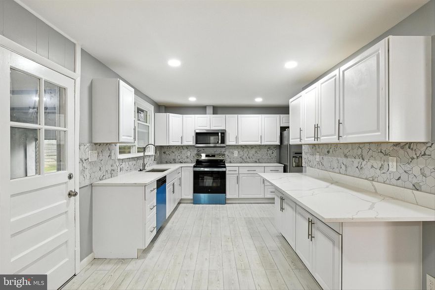 FINANCING SPECIAL!!! NO MONEY DOWN, 100% Financing, NO PMI, 30 YEAR CONVENTIONAL LOAN, $5000 TOWARDS CLOSING LENDER CREDIT! CALL TO QUALIFY. CALL FOR DETAILS.
New Price on this amazing transformation on this completely renovated rancher with over 4000 square feet! This home features stone and siding exterior, brand new roof on house and detached garage, brand new sophisticated kitchen with upgraded cabinetry,  quartz counters and smart appliances. Refinished hardwood floors on and bright large windows are in the great/living room and a brick wood burning fireplace, formal dining room with hardwood floors open to kitchen, 4 spacious bedrooms on the main level each with classic hardwood flooring, primary bathroom is brand new with oversized shower, hall bathroom is also new with a shower/tub combination. The lower level with chic vinyl flooring offers a 5th bedroom and 3rd full bathroom, a large family room with another wood burning fireplace and bar! New heating and cooling system installed. There is an inviting sunroom off the rear of the house overlooking the landscaped yard. Two car oversized detached garage with new door.