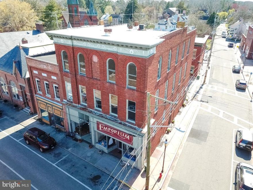 Gorgeous three story, cornerstone "Emporium" Building in the heart of Snow Hill's downtown district. The building is prominently situated at the corner and fronts three streets - Pearl St, Green St, and Bank St. The property has access from each street and features two ground floor commercial spaces (one unit leased for 1 year and second unit leased for 5 years), and apartment rentals on the second and third floor. 

There are two 1bed/1bath units, and two 2bed/1bath units. All apartments have an immense amount of character and charm with floor to ceiling windows and ample amounts of natural light. All floor plans are open and airy with amazing wood working. Apartments can be accessed from Bank St, with one second floor unit being accessible via Green St.