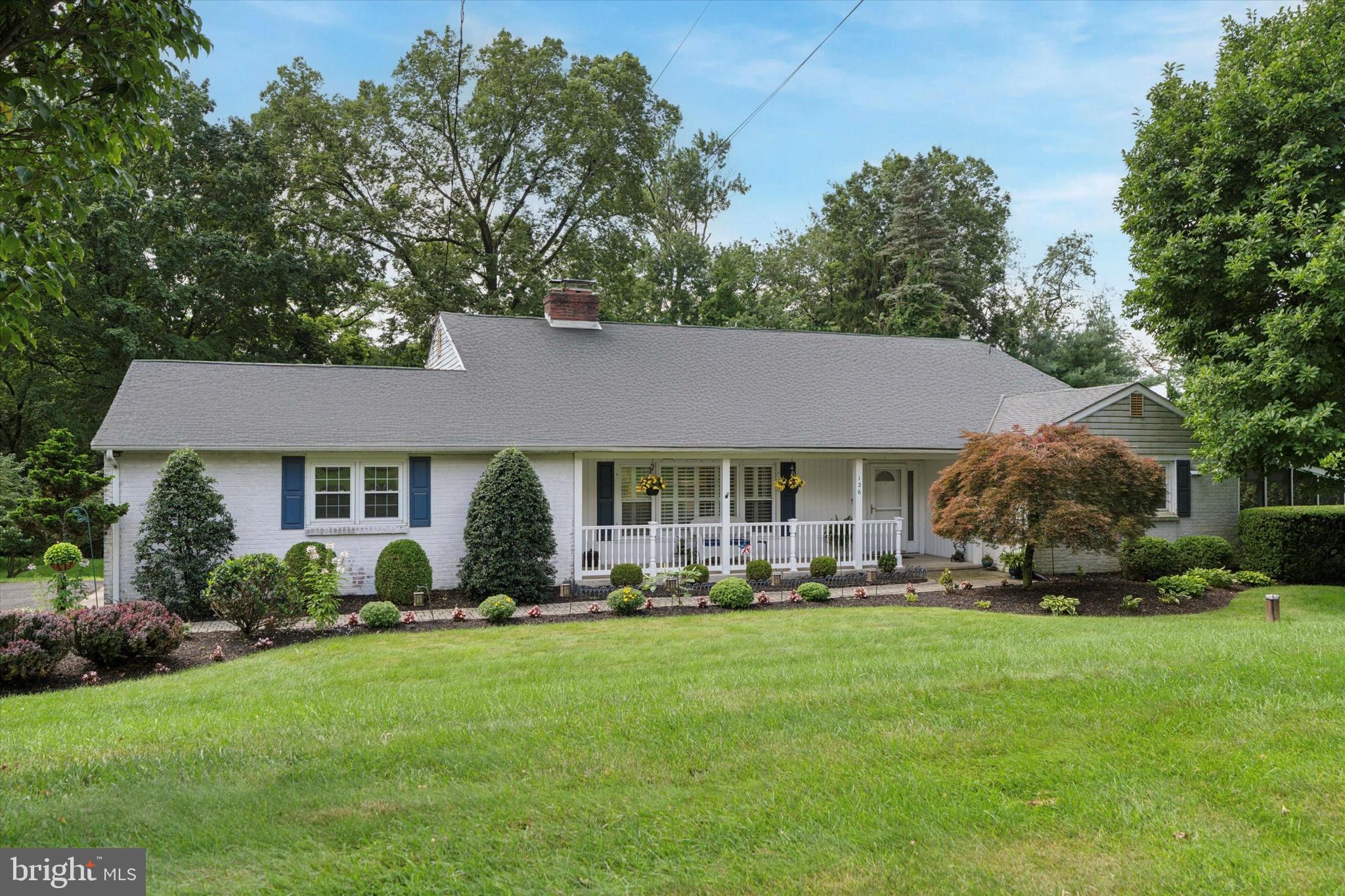 Nestled on half an acre in Mount Eyre Manor, you will find this sprawling custom-built home with a fantastic layout and all of the features you've been searching for. This home has a stately presence and an abundance of curb appeal, from the lush landscaping to the welcoming front porch. Enter to find a well-appointed living room with fireplace and cathedral-height ceilings. An open staircase allows daylight to flow effortlessly through the space. The main living level offers the living room, kitchen, dining room, and outside access. ​It’s a wide, open-layout home that gives you the airy, easy-living vibe of a rancher — but with the bonus of separate levels for privacy, entertaining, or extended family living. A sparkling kitchen features white cabinetry, contrasting granite countertops, and stainless steel appliances. Not to mention, great lighting for cooking and prepping. There are existing propane tanks for the fireplaces and generator, so a gas line could easily be run to the kitchen if a gas cooking range is desired. Step out to the screened 3-season porch, a perfect place to enjoy your morning cup of coffee. It is completely private as it's surrounded by landscaping, and also leads to a convenient patio. The dining room exudes high style with the custom painting & wainscoting. A few short steps up and you'll find the Primary Bedroom Suite, plus two more sun-drenched bedrooms with hardwood floors. The Primary Bedroom suite is spacious and separate from the other bedrooms for privacy, with a gorgeous updated en-suite bathroom that features double vanity with leathered granite top, marble tile backsplash, two additional closets, and a stand-up shower. The 2 additional bedrooms are serviced by a very large hall bathroom, with double vanity and nice neutral wall tile. Next, visit the fully finished lower level with plenty of natural sunlight streaming through the double French doors. Hardwood-look tile and a fireplace give this extra living space a cozy comfortable feel. Bonus - there is another bedroom and full tiled bathroom on this level, perfect for guests or an in-law suite. The French doors lead out to an oversized deck, and a breathtaking private backyard oasis that is surrounded by mature landscaping. Some additional valuable features of this home include: Generac whole-house generator, 300 foot well, water filtration system with reverse osmosis, and an oversized 2-car garage with an additional storage area. This home shows like a masterpiece; it is clean, organized, and beautifully decorated so it's easy to envision yourself in the space. Just imagine all of the ways you can use the many outdoor spaces of this home. Are you someone who likes to watch a thunderstorm roll in while sipping iced tea on the porch? Or maybe you'd like to relax on the deck while watching the kiddos play in the yard. There is plenty of space for hobbies like gardening, grilling gourmet cuisine for family & friends, or simply enjoying the wildlife from the comforts of your shaded hammock. This home offers ample opportunity to slow down and savor life with those you love. This Washington Crossing location combines a quiet neighborhood feel, with close proximity to all of the dining and cultural attractions of bucolic Bucks County. Easy access to New Hope, Yardley, Newtown, and the picturesque Delaware River attractions. Check back for professional photos by 7/19. Showings begin Tuesday 7/22, so be sure to schedule your private tour!