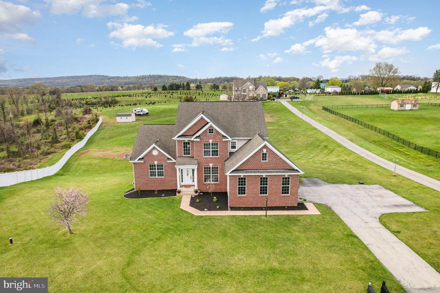 Desirable Rolling Hills Estates on a Sprawling 1.35-Acre Lot! This elegant brick home is nestled in a picturesque country setting, offering both charm and tranquility. The residence offers 5 bedrooms, 3.5 baths, 2 car side entry garage, composite deck and over 2850 sq ft finished. Features a first-floor primary suite complete with a luxurious updated bath with a soaking tub, a tiled walk-in shower, and a spacious walk-in closet. The main level boasts 9-foot ceilings, a formal dining room with crown molding and chair rail, and a family room highlighted by a gas fireplace with a slate surround. The gourmet kitchen is a chef's dream, and the convenient first-floor laundry adds to the home's functionality. Upstairs, you'll find four additional generously sized bedrooms and two full bathrooms. The walk-out basement offers ample storage space and is ready to be finished to suit the next homeowner's needs. Includes a one-year warranty for the buyer.