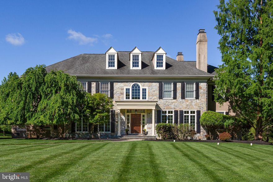 Stately in stature and brimming with timeless curb appeal, welcome to 211 Twinings Lane in the sought-after Whitegate community of Wayne! Built by the esteemed Bentley Homes, this home is truly everything you’ve been looking for: a move-in ready center hall colonial set on a quiet cul-de-sac in a coveted Main Line location. Timeless details include the sweeping front lawn, the foyer’s grand staircase, the two-story stone fireplace, archways separating the rooms, red oak hardwood flooring, and soaring ceilings. Modern convenience hasn’t been forgotten, though, with a spacious, chef-inspired open kitchen with a large center island and custom-built cabinetry, built-in shelving, a three-car attached garage, and many custom upgrades throughout the home. Find all this and more in your dream home: 211 Twinings Lane!  

Upon entering, you immediately take in the home’s dignified atmosphere: with a grand staircase flanked by two arched doorways– each with beautiful casework– leading to the living and formal dining rooms. A center hall colonial, the home embodies excellent front-to-back flow, making it an ideal layout for seamless hosting. The two-story great room features soaring windows and hearth-to-ceiling stone fireplace. A sunroom with a tile floor is located off the great room: a cozy room to relax and enjoy the natural light pouring in from the many windows. The study with built-in cherry wood bookshelves, doors, and windows offers a quiet space for working from home or reading a book. 

The open and spacious gourmet kitchen is a few steps from the great room. The oversized granite-topped island and abundant custom cabinetry are a few of the many upgrades that create this chef-style kitchen. Upgraded appliances include a warming drawer and wine cooler as well as a newly installed touch faucet for added convenience. A classic breakfast room with three sides of windows and access to the spacious patio allows for informal dining indoors or out. A large mudroom, including built-in storage and one of two main level powder rooms, leads one from the attached garage into the kitchen. A second powder room centrally located for guests’ use completes the main level. 

The second floor, accessed by the front or back stairs, boasts a wide hall open to the soaring windows of the great room. There are five bedrooms and 3 baths on this level. Entry to the primary suite is through French doors and a vestibule. The primary suite includes a spacious bedroom, a flexible space which can be used as a sitting room or dressing room with two large, custom closets and an en suite bathroom. The primary bath includes a soaking tub, walk-in shower, and a long vanity with dual his-and-her sinks. An open hall leads to 4 large bedrooms with custom closets and attached baths. A laundry room with counter space and a window allowing natural light completes the second floor. Head upstairs once again to find a partially finished space on the third level with endless possibilities for your customization. 

Upgrades added to this home during construction include sound insulation of the primary suite, house alarm system, lawn sprinkler system, gas fireplace, gas line to patio, full unfinished basement with French door access to outdoor concrete stairs to grade, upgraded cabinetry, woodwork, and hardware throughout. The coveted Whitegate community has a playground and tennis courts for residents' enjoyment, and the Wayne location is convenient to all the Main Line has to offer!