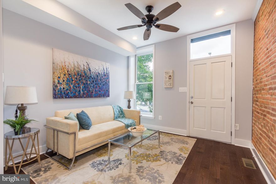 CHAP AND PARKING! 3BR, 2BA home has 4 levels of living space (tax record is incorrect) Home features 3rd story master ste with private bath. Wet bar and access to rooftop deck. Custom kitchen with quartz counters, SS app. and sep. dining space. Exp'd brick, multi-level deck, new hw floors , basement office & w/d are just a few perks in this newly rehabbed home. Parking in rear. 10YR TAX CREDIT