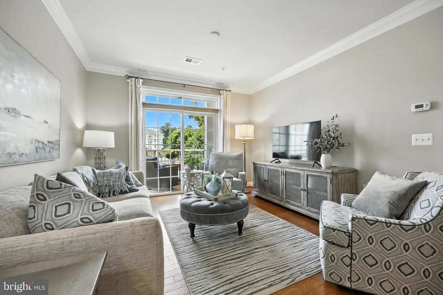 Welcome to this beautifully maintained Vienna PLUS Model, featuring 2 bedrooms, 2 full bathrooms, a versatile den, & a private garage. Designed with both functionality and elegance in mind, this home offers exceptional indoor and outdoor living space, including a 10’x20’ deck and a separate private balcony—ideal for relaxing or entertaining.  The gourmet kitchen is a chef’s dream, showcasing quartz countertops, rich maple cabinetry, gas cooking, and upgraded crown molding and trim. Gleaming hardwood floors flow throughout the main living areas, complemented by custom window treatments and designer lighting.  A full-size washer and dryer add everyday convenience.  Located just 4 miles from the Glenmont Metro (Red Line), 1 mile from the ICC, and about a quarter of a mile from Georgia Avenue, this home offers unbeatable access to major commuter routes while nestled in a quiet, sought-after community.   Situated in Norbeck Crossing, residents enjoy scenic walking trails, a community playground, and beautifully landscaped common areas, all while being conveniently close to shopping, dining, and recreational amenities. Enjoy peace of mind with safe, restricted access to the condo building and modern, well-maintained common areas that enhance the overall living experience.