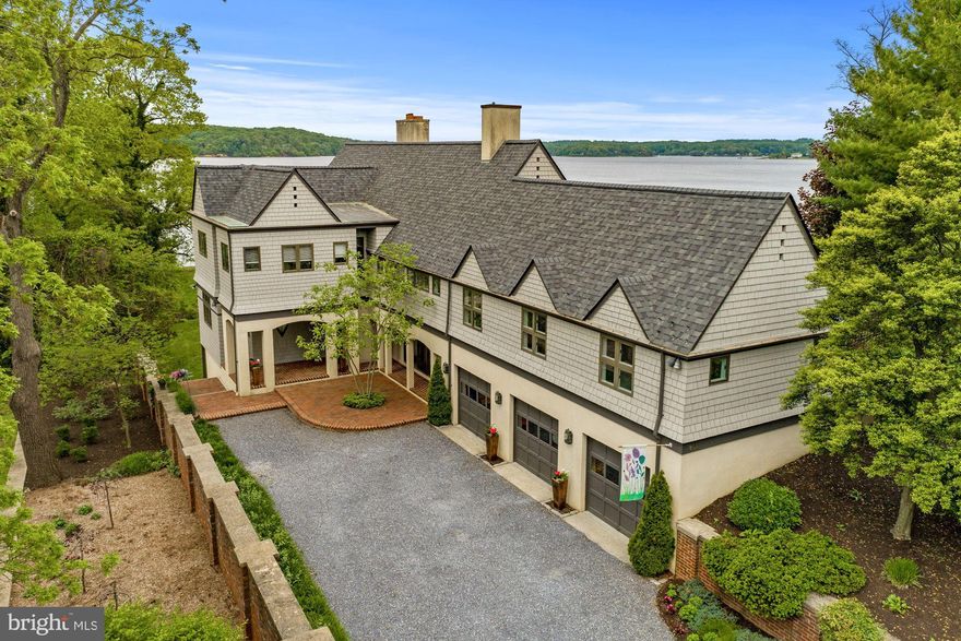 This is the first time this exceptionally built custom waterfront home in the prestigious community of Wroxeter-on-the-Severn has been offered for sale.  Featuring panoramic views of the Severn River and designed in the Flemish Tudor style by nationally recognized award-winning architect, Wayne Good, this home sits on over an acre lot with 150 feet of waterfrontage with a riprap shoreline and water views from almost every room in the home.  Approved pool permit in-hand.  Sellers will not be building a pool, but the permit will convey to the new owners.  Conceptual pool renderings are included in the photo tour.  The serene setting is perfect for catching the breathtaking sunsets over the Severn River, and boating enthusiasts will appreciate both the property's private pier with a spacious Trex maintenance-free party deck with a kayak launch platform as well as an assigned 50 ft deep water slip just a short walk away in the community marina on protected Asquith Creek.  The property's spacious octagonal party deck provides front row seats for the Blue Angels flyover shows, sailboat races, and Sherwood Forest's Independence Day fireworks show.  With a functional design and flexible floor plan, this home provides opportunities for up to seven bedrooms or multiple home offices including a full au-pair/in-law suite with a separate entrance, kitchen, and deck with huge water views.  The waterside screened-in porch with a fireplace is just one of the countless ways this property allows you to take advantage of the stunning water views.  This home features three finished levels with an attached three car garage and was built with high quality materials and finishes throughout.  It showcases solid wood doors throughout with solid brass hardware, a true chef's kitchen with new appliances and solid wood cabinetry, a new washer and dryer in the large upper level laundry room, a centralized audio system throughout, a brand new roof with architectural shingles, solid hardwood floors and brand new carpeting, recessed lighting throughout, and many more high end elements.  This is an amazing opportunity in one of the most desirable neighborhoods on the Severn River which is conveniently located just a few miles from the US Naval Academy, the Annapolis Historic District, and major commuter roads.