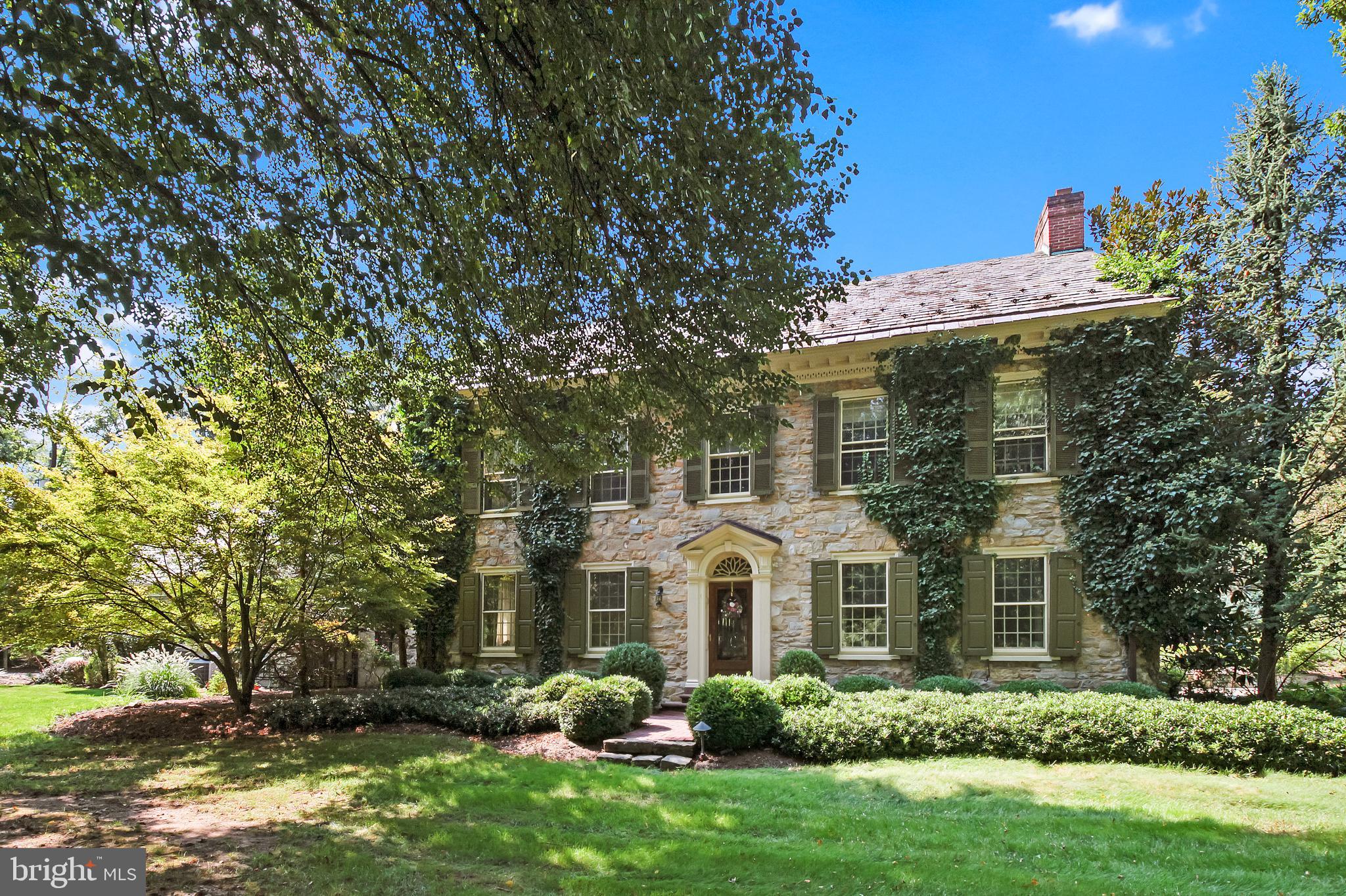 Once in a lifetime opportunity to own this Historic 3-story stone home on 2.54 acres nestled in the heart of the prestigious Wyomissing Park System. Built in the late 1800s, this 5 bedroom and 3 and 1/2 bath 5000 square foot home has been lovingly restored and renovated with all the modern amenities. This stunning home features original architectural details including hardwood flooring, deep window sills, 9+ foot ceilings and crown molding, as well as built in corner cabinets and 3 fireplaces. There is a large circular driveway with access to the attached 2-car oversized garage and a beautiful stone patio with lots of shade trees. As soon as you enter into the foyer, you will notice all of the architectural details this home has to offer. To the right, is a very large formal dining room with corner built-ins, chair rail and crown molding. The spacious, formal living room is off to the left of the entrance foyer and comes with a wood burning fireplace with decorative mantel, built-in cabinets, beamed ceiling and crown molding and chair rail. The updated gourmet kitchen features a 6-burner gas range/double oven, a center island with vegetable sink, peninsula seating, beamed ceilings with shiplap, cooper farmhouse sink and cooper range hood, granite countertops with tile backsplash, insta-hot faucet and recessed lighting and access to the breakfast area with a propane stone fireplace, cathedral beamed ceilings, recessed lighting and French patio doors to the outside. The family room features a wood beamed ceiling, built-in cabinetry, recessed lighting, sliders to the huge side stone patio and a wood burning fireplace with mantel. The first floor also has a laundry room with built-in cabinets and a laundry sink and mudroom with custom lockers and brick flooring. As you work your way to the second level, take note of the gorgeous crown and chair rail winding its way up the staircase. At the top of the stairs sits the stunning master bedroom suite, complete with a dressing area with tons of closets, an updated large master bath with tile flooring/backsplash and a tile/glass shower and a separate walk-in closet with built-ins. Two additional large bedrooms with wood flooring and large closets and an updated hall bath with a tile/glass shower and tile flooring compliment this level. The third level of this enormous home holds two more bedrooms, one with a full bath with tub/shower combination and tile floor, and the other with a walk-in cedar closet. The finished walk-out lower level recreation room features built-in cabinetry and a wet/dry bar and there is also a large storage area. In addition, there is a finished bank barn for more entertainment which has a full bath with brick flooring and stall shower on the main level and the upper level comes with a beautiful beamed, cathedral ceiling, built-in cabinetry and sink and a large heater. There is also a heated, salt water inground pool for those warm summer days, exterior lighting, extensive hardscaping, security system and irrigation system for the gardens and a slate roof. There are too many amenities to mention them all! This home sits close to the Wyomissing School District, Tower Health, restaurants and shopping, walking and bike trails---Come take a look---you will not be disappointed!