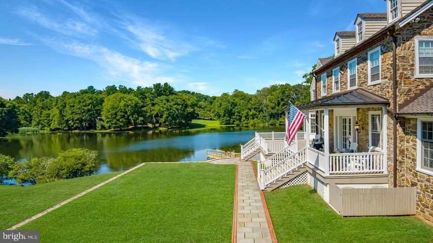 In the epicenter of historic Chadds Ford, Dewson Construction with top of the line craftsmanship and details, a classic Pennsylvania stone masterpiece is perched on the banks of Karver Lake.  Embracing its 7-acre water front setting, the architectural heritage of an historic home is echoed in character with an expansive Archer-Buchanan designed home.  With respect to its Georgian architectural vernacular but ushering in a lightened style and spacious aesthetic, all-important views are oriented toward the lake.  The stone of an original jewel was carefully matched for use on the front facades and in the hardscape walls that frame the lawns. Natural light floods the foyer and grand staircase.  Richly stained reclaimed white oak floors blanket main and upper levels, and provide classic contrast to the warm, neutral pallet.  Paneled doors paired with meticulously reproduced and repurposed historical hardware punctuate every space with weight and scale amplified by 10' ceilings.    Working from home takes on a delightfully new meaning in the pair of offices off the main entrance, or study on 2nd level.   Maintaining the homes historical integrity, the gathering space opposite the offices features two original fireplaces, coffered ceilings and casually elegant dining.  Beyond, an original stone wall and three window walls provide a sunny retreat for relaxation, home school or play.  The dramatic heart of the home is carefully appointed with richly grained custom cabinetry and built-in fine appliances, topped with subtle stone and wood counters. French doors invite outside living with water front ringside seats to the changing seasons.  The family friendly space with both banquette and bar stool seating spills into the comfortable family room with plenty of space for family and friends to sprawl.  Stone fireplace, carved mantle and built-in cabinets that compliment those in the kitchen create architectural interest and charm.  Main floor mudroom with built-in cubbies, laundry with copper potting sink, walk in pantry, walk in storage closet and two well appointed powder rooms fulfill every wish list and serve every need.  Up the back stairs, the master suite offers the amenities and understated elegance of a four star hotel. Private walk in closets, bathroom accommodations for two take the amenities to a higher level, and tucked into the hallways a shoe closet, linen closet, suitcase closet and additional storage are skillfully arranged.  Family and guests are well served in three additional spacious bedrooms, en suite.    In a wing of the second floor, the second laundry, and au pair suite offer private accommodations and sitting room.  Blending modern convenience and old world charm, the third floor plays host to two additional bedrooms, and bath, as well as bonus finished spaces.  The daylight lower level has a fully appointed fitness suite, highlighted by a steam shower and separate sauna.  A kitchenette adds service to the lounge area, craft space & play room.  An accessory three bay carriage house enhances the integral two-car garage with ample additional storage for garden equipment.   Bespoke details celebrate the medley of craftsmen enlisted for the lake house.  And while quality is evident at every turn, the comfort and convenience of state of the art mechanicals add to the litany of attributes this property has to offer.