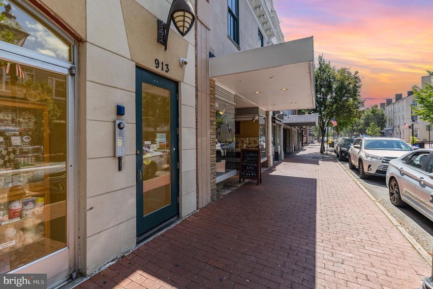 Welcome to 913B Caroline Street, a rare and luxurious condominium in the heart of historic downtown Fredericksburg with 4200+ square feet.

Caroline Street has long been one of Fredericksburg’s principal downtown corridors—once the town’s main retail and commercial streets, and today part of the city’s treasured National Historic District. In the late 20th and early 21st centuries, downtown saw a thoughtful mix of preservation and selective new construction, designed to revitalize the area while maintaining its historic character. The development at 913 Caroline Street, completed in 2007, is a prime example of this approach: a contemporary, large-footprint condominium built into the historic fabric of the street. While not an 18th- or 19th-century structure itself, it reflects Fredericksburg’s commitment to combining preservation with carefully scaled new design to enhance downtown living.

Within this boutique building of only three private residences, 913B is one of the city’s largest condominium homes. Perfectly positioned on the second floor, it offers stunning winter views of the Rappahannock River and a front-row seat to the energy of downtown.  Enter through the private door either on Caroline Street, or from Sophia St near the private parking garage.

Once inside the secure main entrance, enjoy a quick elevator ride to your floor. A wide hallway leads to the front door where a gracious entry sets the tone with 10’ ceilings. Inside, the center hallway is lined with cherry built-in bookshelves, perfect for displaying artwork, guiding you into the heart of this exceptional home. 

The layout includes two primary suites, each with big walk-in closets. The two large bedrooms share a hallway creating their own wing - the hallway between the rooms leads to a large spa-like bath with shower and soaking tubs.  Dual sinks are back to back, so there's plenty of storage space, too. Both rooms have tray ceilings and custom lighting.  Across the main hall on the opposite side, is a third bedroom with an en-suite bathroom for guests or family, creating privacy and plenty of space for everyone. 

Beyond the bedrooms, the residence opens into a magnificent entertainment and living space.  A music alcove provides the perfect spot for a piano or reading nook. Expansive windows and glass doors frame treetop views of the riverbank, opening onto a full-length balcony ideal for morning coffee or evening sunsets. A dedicated home office with more cherry built-ins offers flexibility for work, a den, or even a potential fourth bedroom.

The airy kitchen features granite counters, a butcher's block, a central island, and abundant cabinetry, with a cozy sitting area that doubles as a breakfast nook. A large pantry just off the kitchen provides shelving, a sink, laundry, prep space, and additional storage. 

At the rear of the building, residents enjoy secure, gated garage access with two assigned parking spaces, visitor spots, elevator service, and convenient street entry.

With just three residences in the building, opportunities to own here are exceedingly rare. More than a home, 913B Caroline Street offers a carefree lifestyle in a historic riverfront town, within easy walking distance of the Virginia Railway Express, restaurants, boutiques, coffee shops, art galleries, and the riverfront park.