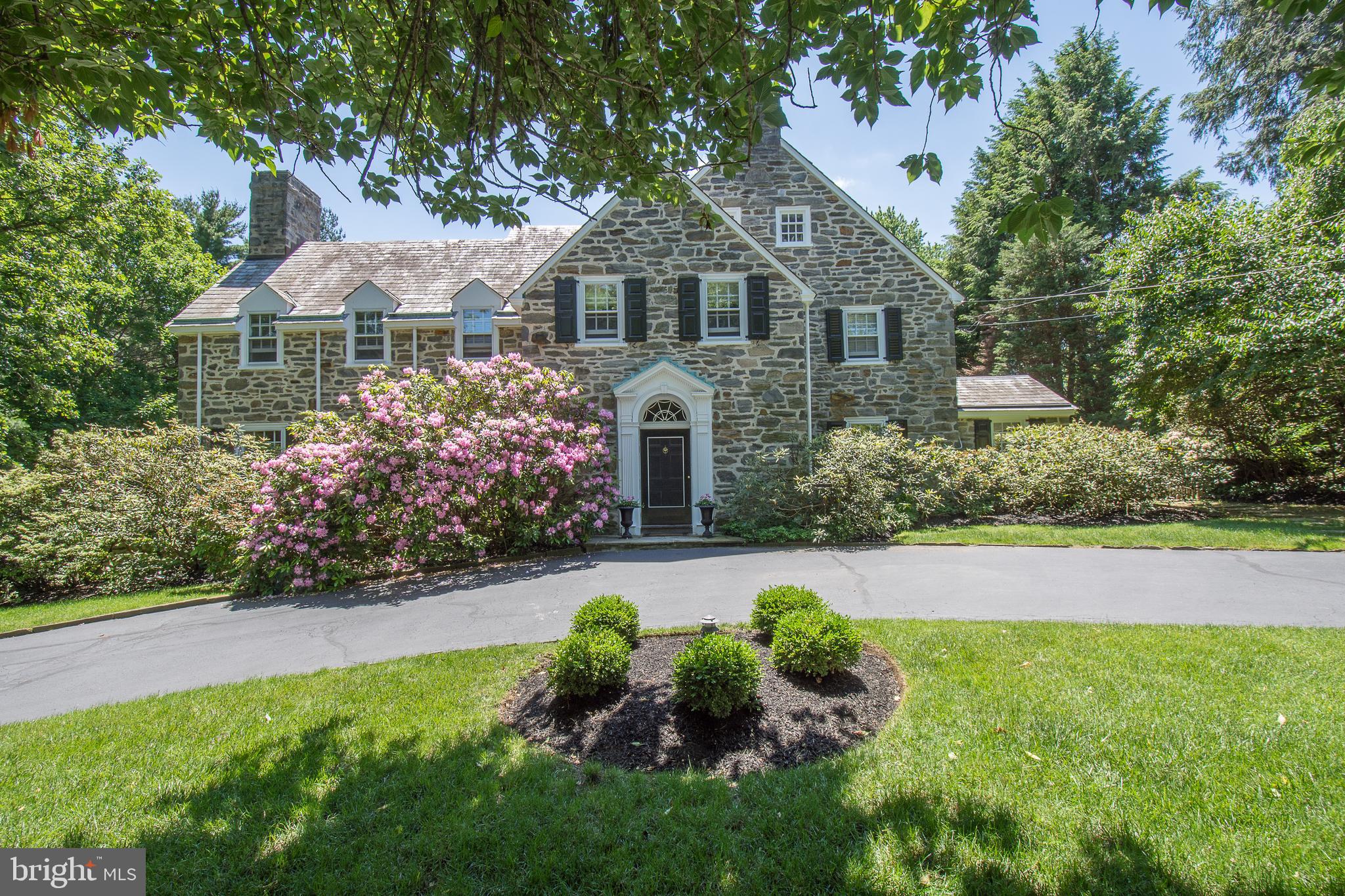 Striking all stone 6 bedroom 4 full 2 1/2 bath home pairs exceptional architectural styling with a fresh, updated interior. Offering bright, connected family spaces, sparkling all white renovated Kitchen and spectacular volume ceilinged Family Room with fireplace and floor to ceiling windows. Located in a "walk to train" neighborhood this home features an expanded exciting floor plan, finished on three levels with 6 spacious Bedrooms, generous closet space and a Master Suite with fireplace, en suite Bath, Dressing Room and wide private Balcony which overlooks the Pool, Reflecting Pond, flat lawn and Gardens. With outside access, the fully finished Lower Level provides additional informal entertaining and family gathering space. A fireplace, Wet Bar, Wine Storage and rustically paneled Great Room is adjacent to the ping pong room and primary storage. A true classic, updated to today's design standards with a professionally selected neutral color palette and move-in ready styling. Exceptional. By appointment only.
