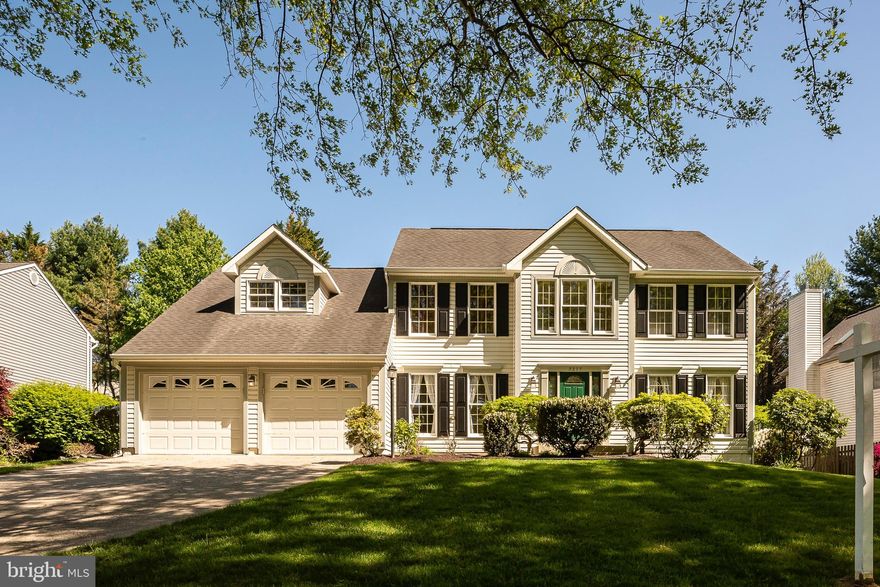 Stunning colonial located on a park-like lot in Ellicott City!  This well cared for home is filled with all the right upgrades.  The Chef's kitchen features custom wood cabinetry, granite countertops, upgraded lighting, high-end Thermador electric cooktop, stainless steel exhaust hood, Thermador convection oven, Sharp convection microwave, built-in warming drawer and super quiet Bosch dishwasher.  The spacious family room adjacent to the kitchen is filled with natural light and features vaulted ceilings with two skylights, a cozy gas fireplace and a bar area with beverage refrigerator.  The formal dining room features classic chair rail and crown molding.  The formal living room offers a bay window, crown molding and French doors to the convenient, main level office.  The large mudroom has a  front loading, LG washer & dryer, a utility sink and easy access to the two car garage.  A private half bath completes the main level. The primary bedroom suite features vaulted ceilings, a walk-in closet, an additional double closet and a luxury bath with double sink/vanity, soaking tub, glass enclosed shower and two skylights for tons of natural light. There are three additional bedrooms with plenty of closet space and a remodeled (2014) hall bath with double sink/vanity, granite countertops and Kohler fixtures.  The lower level adds additional living space with a game room, flexible living area ideal for home gym, a half bath and a large workshop and storage area. The private back yard is fenced and features a relaxing deck built in 2014, a paver patio and professional landscaping with walking paths and flowering trees. Recent mechanical updates include a new furnace and AC in 2018 with NEST programable thermostat. This home is conveniently located near schools, shopping and commuter routes and has nearby access to Patapsco State Park.