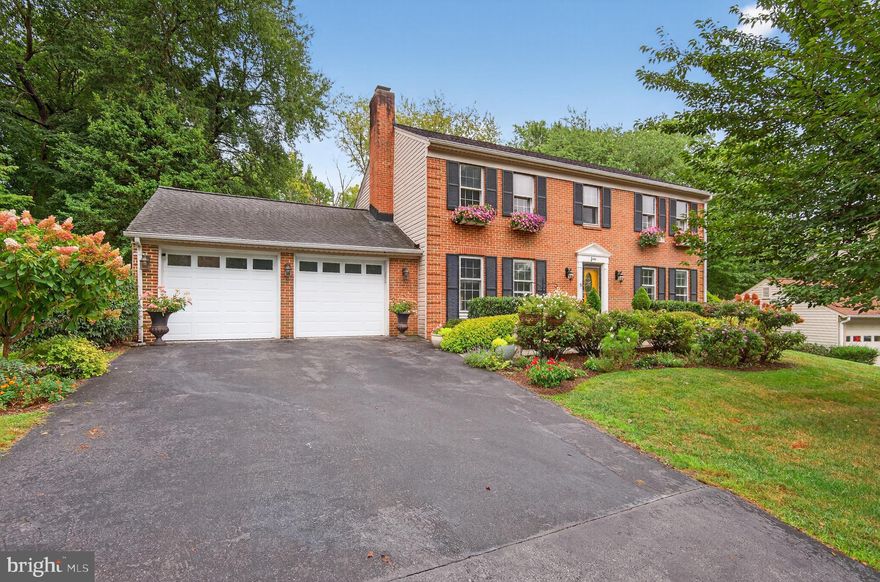 Welcome to this delightful 6-bedroom, 3.5-bath colonial, perfectly positioned on a generous 16,900 sq. ft. lot in the highly sought-after Westleigh neighborhood. The timeless brick-front exterior, accented with shutters and garden planters, is complemented by a serene outdoor retreat surrounded by mature trees. Inside, the light-filled living room features recessed lighting and a large built-in bookcase, offering the ideal setting for a personal library or display. Just beyond, the inviting family room showcases beamed ceilings and a cozy wood-burning fireplace, creating a warm and welcoming atmosphere. The updated kitchen is a true highlight with rich wood cabinetry, stainless steel appliances, a tiled backsplash, and a sunny breakfast nook that opens directly to the rear deck—perfect for enjoying peaceful garden views. A formal dining room, powder room, and laundry room complete the main level, providing both comfort and convenience. Upstairs, the spacious owner’s suite provides a private retreat with a walk-in closet and an en-suite bath featuring dual sinks and a tiled bath/shower. Four additional well-appointed bedrooms, each with generous closet space, along with an updated shared full bath, ensure plenty of room for everyone. The walkout lower level expands the living space with a large recreation room highlighted by recessed lighting, custom built-ins, and direct access to the backyard retreat. A sixth bedroom, full bath, and extra storage provide flexibility for a home office, guest quarters, or an in-law suite. Step outside to your own private oasis, perfect for entertaining or unwinding. Enjoy tree-lined views from the rear deck, gather on the stone patio (added in 2021) with its hardscaped dining areas, or take in the expansive yard framed by mature trees. Attached two-car garage with long driveway offers off-street parking for up to 6 cars plus plenty of street parking available for guests. With no HOA and ideally located near Kentlands, RIO, and Downtown Crown, this is a gem! Zoned to Wootton HS, Robert Frost MS and Dufief ES cluster!