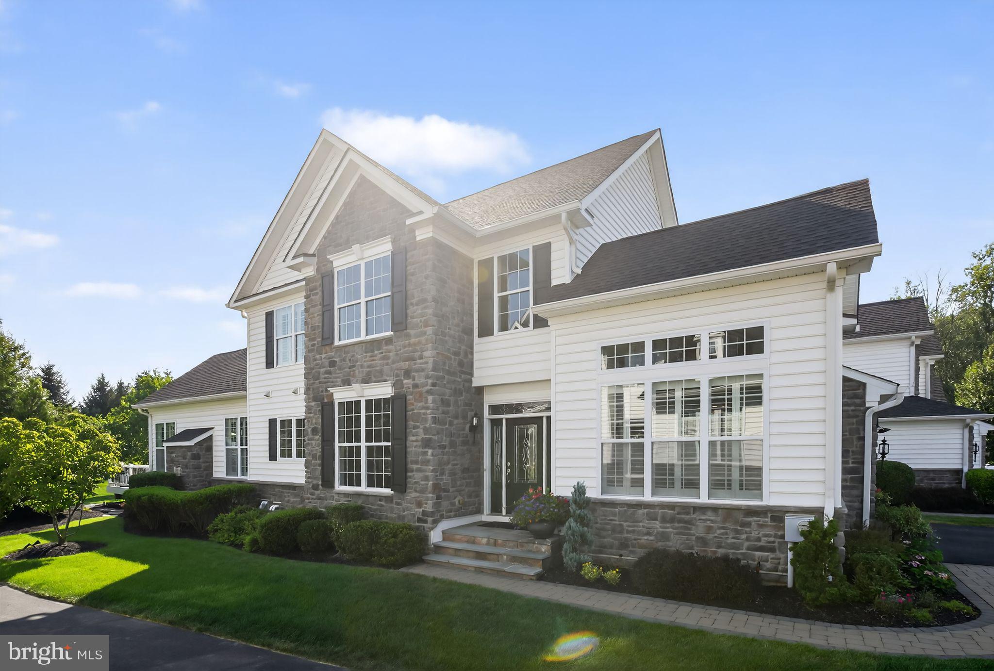 Open House Saturday August 16 and Sunday August 17. Noon to 2pm. Welcome to 69 Hillyer Lane, a stunning End Unit carriage home located in the highly acclaimed The Enclave at Upper Makefield, a desirable active adult community. This Bucknell model, located on a cul-de-sac, offers an open floorplan with sophistication and style, setting the tone for the quality of craftmanship and ease of functionality. Upon entering this lovely home, you are enveloped by a dramatic two story foyer with elegant wooden stairs and upgraded balusters to the second floor. The main level has hardwood flooring, crown molding, and plantation shudders throughout. Off the foyer to the right is the sun-filled study with vaulted ceiling and architectural windows. The stylish gourmet kitchen is enhanced by granite countertops, white cabinetry, and a large contrasting island with cabinets. The well thought out large panty has built-in shelving and pullout drawers. The tiled backsplash is a stunning accent. A suite of stainless-steel Kitchen Aid appliances including a cooktop, combination wall oven/microwave make meal prep a dream. While enjoying your meal, reach into the built-in wine cooler at the butler’s pantry.
The kitchen opens to the great room with an updated gas fireplace surrounded by floor to ceiling exquisite stack stone. The cathedral ceiling’s crown molding and additional decorative trim, along with the mood changing up lighting, offers you a unique experience in living well.
From the great room you enter the spacious main floor primary bedroom. Both the great room and the primary bedroom are the expanded Bucknell, which adds precious square footage. The bedroom has a tray ceiling, ceiling fan and an ensuite spa-like bathroom with radiant heated tiled floor, dual vanities, an expansive, beautifully tiled shower with seat, and a large walk-in closet with motion sensor lights and custom built-ins. Rounding out this floor is the powder room with beautifully artistic tile work and the large laundry room complete with sink and plenty of wall cabinets.
Also, from the great room you can step outside to your Trex deck or paver patio and enjoy the very private, park-like surroundings. The only things you see and hear in your backyard are trees, birds, and deer.
Upstairs you will find a spacious open loft offering additional living space or another office, with views of the main level. Two large bedrooms and a jack and jill bathroom with two dual vanities complete the second floor.
A finished, expansive, carpeted lower level offers unlimited possibilities with fantastic storage and plumbed for additional bathroom. Additional home amenities include a 2-car garage, reverse osmosis water treatment, whole house Aprilaire humidifiers, and multi-zone HVAC. This stunning home shows like a model and is move-in ready. Enjoy maintenance free living! A short drive to Newtown Boro, New Hope or Yardley for fabulous shopping and dining along with easy access to the I-295/95 corridor. 30 minutes to Princeton, 45 to Philadelphia and 90 minutes to the Jersey Shore and Manhattan. See our Virtual Tour link for this home.
