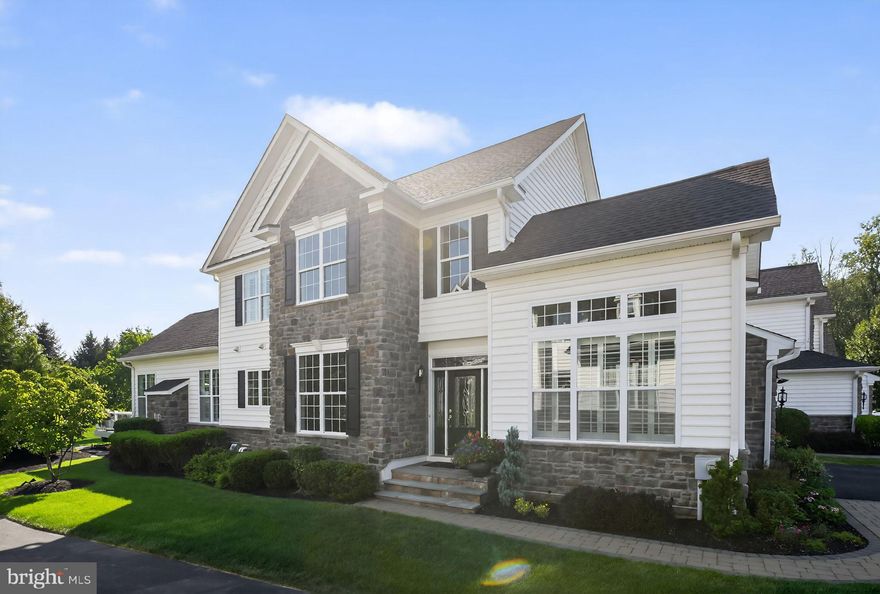 Welcome to 69 Hillyer Lane, a stunning End Unit carriage home located in the highly acclaimed The Enclave at Upper Makefield, a desirable active adult community. This Bucknell model, located on a cul-de-sac, offers an open floorplan with sophistication and style, setting the tone for the quality of craftmanship and ease of functionality. Upon entering this lovely home, you are enveloped by a dramatic two story foyer with elegant wooden stairs and upgraded balusters to the second floor. The main level has hardwood flooring, crown molding, and plantation shudders throughout. Off the foyer to the right is the sun-filled study with vaulted ceiling and architectural windows. The stylish gourmet kitchen is enhanced by granite countertops, white cabinetry, and a large contrasting island with cabinets. The well thought out large panty has built-in shelving and pullout drawers. The tiled backsplash is a stunning accent. A suite of stainless-steel Kitchen Aid appliances including a cooktop, combination wall oven/microwave make meal prep a dream. While enjoying your meal, reach into the built-in wine cooler at the butler’s pantry. 
The kitchen opens to the great room with an updated gas fireplace surrounded by floor to ceiling exquisite stack stone. The cathedral ceiling’s crown molding and additional decorative trim, along with the mood changing up lighting, offers you a unique experience in living well. 
From the great room you enter the spacious main floor primary bedroom. Both the great room and the primary bedroom are the expanded Bucknell, which adds precious square footage. The bedroom has a tray ceiling, ceiling fan and an ensuite spa-like bathroom with radiant heated tiled floor, dual vanities, an expansive, beautifully tiled shower with seat, and a large walk-in closet with motion sensor lights and custom built-ins. Rounding out this floor is the powder room with beautifully artistic tile work and the large laundry room complete with sink and plenty of wall cabinets. 
Also, from the great room you can step outside to your Trex deck or paver patio and enjoy the very private, park-like surroundings. The only things you see and hear in your backyard are trees, birds, and deer.
Upstairs you will find a spacious open loft offering additional living space or another office, with views of the main level. Two large bedrooms and a jack and jill bathroom with two dual vanities complete the second floor. 
A finished, expansive, carpeted lower level offers unlimited possibilities with fantastic storage and plumbed for additional bathroom. Additional home amenities include a 2-car garage, reverse osmosis water treatment, whole house Aprilaire humidifiers, and multi-zone HVAC. This stunning home shows like a model and is move-in ready. Enjoy maintenance free living! A short drive to Newtown Boro, New Hope or Yardley for fabulous shopping and dining along with easy access to the I-295/95 corridor. 30 minutes to Princeton, 45 to Philadelphia and 90 minutes to the Jersey Shore and Manhattan.  See our Virtual Tour link for this home.