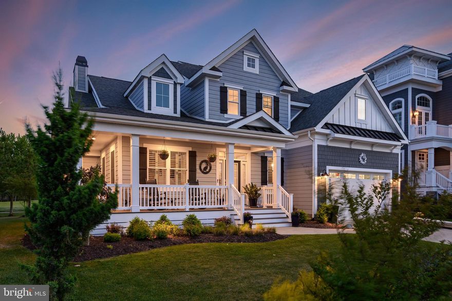 Welcome to luxury coastal living in this stunning Schell Kingfisher model, perfectly positioned along the 5th fairway of the prestigious Jack Nicklaus Signature Golf Course at Bayside Resort.  From the inviting wraparound front porch to the thoughtfully curated outdoor living spaces, every detail of this exceptional home has been designed to impress. Step inside the grand foyer and discover rich hickory hardwood flooring, custom millwork, soaring ceilings, and expansive windows and doors that beautifully frame the surrounding golf course and natural landscape. A private home office sits just off the entry, offering the perfect work-from-home retreat. The open-concept great room seamlessly connects to the gourmet kitchen, creating an ideal setting for entertaining. The chef’s kitchen features crisp white cabinetry, Viking appliances, quartz countertops, and an oversized island designed for gathering. Anchoring the great room is a dramatic floor-to-ceiling stone fireplace accented with custom shiplap and elegant built-ins. Oversized glass doors glide open to the newly finished covered patio, creating effortless indoor-outdoor living. Nearby, the dining area showcases coffered ceilings, designer lighting, and glass doors that open to a spectacular patio overlooking the fairway. The spacious main-level primary suite offers a peaceful retreat with a tray ceiling, dual walk-in closets, and a luxurious spa-inspired bath complete with double vanities, a beautifully tiled shower, and an additional vanity area. The main level also features a beautifully appointed powder room with classic wainscoting and a pedestal sink, along with a spacious laundry room offering additional cabinetry and a ceramic sink for added convenience.  Upstairs, guests will enjoy an open loft perfect for relaxing after a day at the beach or on the course. Three beautifully appointed bedrooms provide ample accommodations, including a second bedroom with a private balcony showcasing breathtaking views of the fairway, pond, and surrounding coastal nature. A cheerful third bedroom features a large walk-in closet and access to a hall bath, while the expansive bonus room includes its own custom bath and walk-in closet.  Outdoor living takes center stage with show-stopping covered patios, a stunning gas fire pit integrated into a custom paver wall, manicured landscaping, and direct golf course access. Located within the award-winning Bayside Resort community, this exceptional home offers world-class golf, pools, fitness amenities, dining, beaches, and an unmatched coastal lifestyle.
