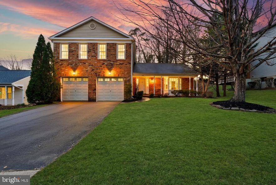 From the moment you pull up to this classic brick colonial, the curb appeal sets the tone — but nothing prepares you for what's inside. This is a top-to-bottom, no-shortcuts renovation, and the photos don't even do it full justice.

The kitchen is the showstopper. A custom 10½-foot island with full waterfall marble countertops anchors a space that was clearly designed with intention — dark espresso cabinetry with brushed gold hardware, double pantry cabinets with soft-close doors and drawers, new stainless appliances, and a marble picket backsplash that runs floor to ceiling. The sellers added custom double windows and a new sliding door across the back of the main level, and the natural light that pours through is something you have to see in person. The kitchen, dining, and living areas all flow together seamlessly with new LVP floors throughout. The living room features a wood slat accent wall that stops buyers in their tracks, and the family room off the kitchen has a gas fireplace with a crisp white brick surround and brand new sliding doors opening to the deck.

Every bathroom was touched, and most were completely reimagined. The primary bath features floor-to-ceiling marble slab in the shower with brushed gold fixtures, a double vanity with warm wood cabinetry and gold-framed mirrors, and walk-in closet access — spa-level finishes at every turn. The hall bath was fully remodeled with stacked vertical tile, a herringbone accent niche, and hexagon marble flooring. The powder room on the main level got a full glow-up — bold blue paint, natural wood vanity, and gold fixtures. The newly added full bath in the lower level carries the same elevated finish standard with a clean, modern vanity and marble counter.

The lower level is wide open — new carpet, recessed lighting throughout, and a new den (not a legal bedroom) that works perfectly as a home office, playroom, or gym. Upstairs, the primary bedroom is spacious with new LVP and recessed lights. New stacked washer and dryer are tucked efficiently on the upper level with closet storage alongside. Out back — new deck, new stamped concrete patio, new HVAC, roof approximately 2014.

And the location? This is Rolling Forest — a peaceful, established subdivision with community pool access, tucked just minutes from Springfield Town Center and quick connectivity to the Fairfax County Parkway and I-95/I-395. The neighborhood sits conveniently between Old Keene Mill Road and the Springfield Parkway, and the Springfield Metro and Lorton VRE are about an 8-minute drive — making this one of the better commuter locations in Fairfax County. Whether you're heading into the Pentagon corridor, Fort Belvoir, or downtown DC, you've got options.

Approximately $140,000 in updates! This is the one!