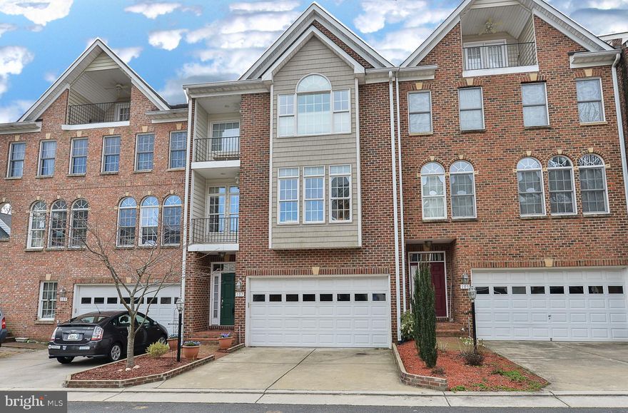 Ideally located within walking distance to the charming shops and acclaimed dining of Historic Occoquan, this rarely available brick-front townhome by Westwynde Homes is nestled on a private cul-de-sac in the sought-after Washington Square enclave. Boasting four beautifully finished levels, this gracious residence offers a seamless blend of timeless sophistication and thoughtful modern updates.  The home welcomes you with a light-filled entry foyer and a neutral color palette that flows throughout. The main living area showcases a warm and inviting family room with a cozy fireplace and custom built-ins, leading effortlessly into a bright breakfast area with access to a private rear deck—perfect for morning coffee or al fresco dining.  The gourmet kitchen is appointed with granite countertops, abundant prep space, and a generous pantry, ideally situated adjacent to the formal dining room. Featuring a charming box bay window and private balcony access, the dining area is ideal for entertaining. A versatile lounge or home office completes the main level, offering serene space for work or relaxation.  Gleaming hardwood floors extend into the upper level, complementing the home's elegant design. The expansive primary suite is a true retreat, with soaring ceilings, a walk-in closet, a sunlit box bay window, and its own private balcony. The spa-inspired en suite bath includes a soaking tub and separate shower. Two additional bedrooms share a well-appointed hall bath, while the top-floor loft provides a fourth bedroom, full bath, walk-in closet, and a third private balcony.  The lower level offers a comfortable recreation room with a second fireplace and sliding glass doors opening to a covered patio and fully fenced backyard, complete with a storage shed. A two-car garage provides added convenience.  Perfectly positioned for commuters, the home offers easy access to I-95, Route 123, Fort Belvoir, and Route 234. PRTC bus routes and nearby slug lines offer efficient connections to the Pentagon and Washington, D.C.  This immaculately maintained residence combines comfort, style, and convenience, an exceptional offering in a truly special location.