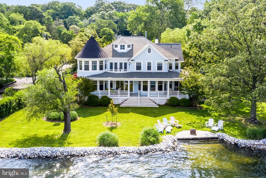 Round Bay waterfront home  offers sunset views of the widest section of the Severn River & 102 ft of non riparian waterfront.   Waterside porch, fire pit patio and a mooring for your boat! Wisteria covered porch welcomes you to this 5 bedroom, 4.5 bath home offering over 5400 SF of comfortable living spaces and a detached 2 car garage. Quality construction & open floor plan home with 3 finished levels. Spacious gourmet kitchen with marble counters, master suite with separate dressing area, bath and sitting room. Round Bay is an established multi-generational water community with 3 piers, beaches, swim team, tennis and boating. It is known for its summer camps, year round activities and social events.