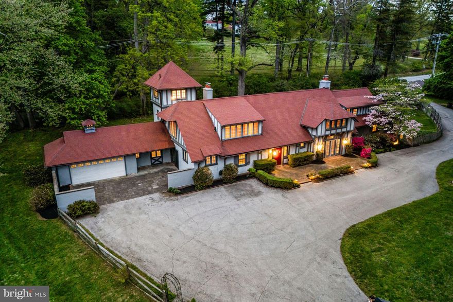 Charm abounds both inside and out at this one- of- a -kind 1901- built carriage house, set on a breathtaking 1.62-acre lot with private views at every turn and a tennis court in coveted Radnor Township. Beautifully restored, original architectural designs and materials have been seamlessly blended with modern renovations within an open, sun-filled floorplan with gracious room sizes and flexible living spaces. Endless features include tile or hardwood floors with freshly painted neutral decor throughout, recently renovated white kitchen with chef's appliances including a gas range, 4 renovated baths, including the primary bathroom which is artistically located in the stately cupola, a spacious entry foyer, expansive great room with bright windows, breakfast room and family room off of the kitchen, large library with fireplace and custom built-ins and a first floor suite area which could either serve as an in-law wing or large gym with full bathroom, laundry and access to the 2-car garage. Both the main foyer staircase and a secondary staircase off of the kitchen lead up to a well-designed second level showcasing a wonderful primary suite with high ceilings, a showstopper bathroom and plentiful closet space, a second bedroom with en-suite bathroom and a third and fourth bedroom/ pass through lounge with Jack and Jill bathroom. Once part of a grand Radnor estate, this rare gem still offers a wonderful retreat just minutes from Renowned Radnor and countless private schools, all forms of transportation including the Ardmore Amtrak station, a wide array of restaurants and shopping venues, clubs, diverse recreational facilities, Center City Philadelphia and Philadelphia International Airport. This treasure won't last long!