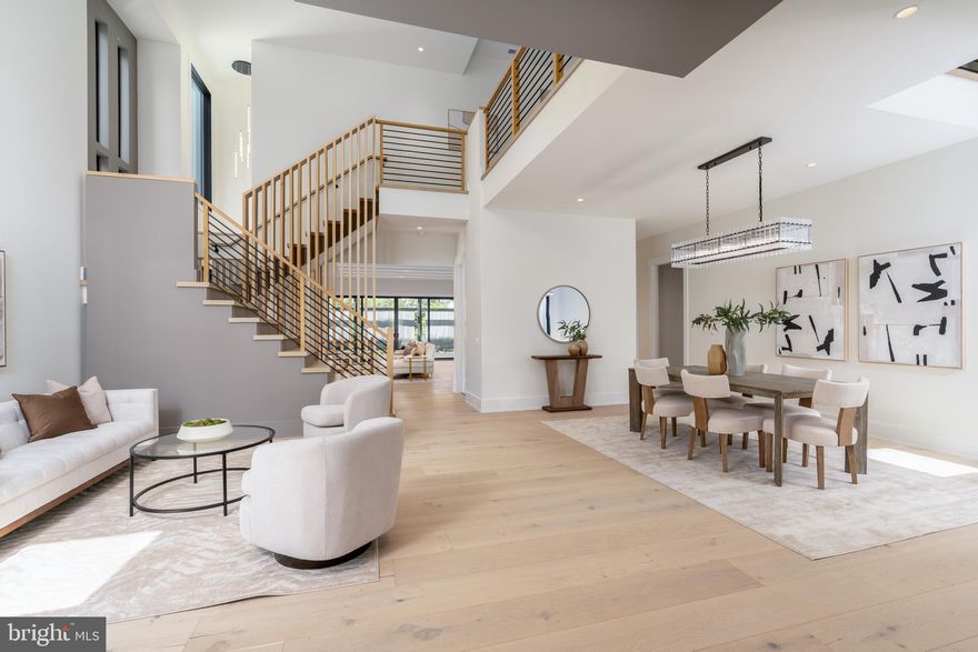 Experience elevated living in this luxury new construction architectural gem—where thoughtful design, luxury finishes, and a prime location just steps from Westwood Country Club come together seamlessly. Designed with entertaining in mind, this home offers the perfect setting for hosting everything from large celebrations to intimate gatherings with ease and elegance.
A dramatic two-story foyer welcomes you into over 7,450 square feet of artfully crafted living space featuring 7 bedrooms and 6.5 bathrooms. The open floor plan flows effortlessly through formal and informal living areas, highlighted by 10-foot ceilings, expansive picture windows, and warm wide-plank hardwood floors throughout the main level. The chef’s kitchen is a true showstopper—complete with a 9-foot center island. For easy everyday living there is a supplemental culinary food prep with a large sink, serving counter, built-in cabinetry and a second dishwasher. Miele appliances, a 60-inch side by side refrigerator, a built-in plumbed coffee station, and a separate butler’s pantry, all beautifully designed for everyday living and effortless entertaining.
The family room features a sleek ceiling design with integrated tape lighting, a linear gas fireplace with passive heat flow, and a wall of windows that open to a massive deck with a trellis-style ceiling and shades—creating a seamless indoor-outdoor experience for guests. There is also a screened porch which is accessible from the kitchen, family room and the deck.  Round out the main level is a secondary suite that can be used as an office or bedroom, adding to the versatility of the home's layout. Completing the main level is a spacious three-car tandem garage equipped with two EV charging outlets.
The open staircase, detailed with custom Poplar wood partitions, is a design centerpiece leading to the second level where you are greeted by a spacious informal living area. The primary suite is a luxurious retreat featuring its own heating and cooling system, two walk-in closets, a spa-inspired bath, and a private sitting room with fireplace—ideal for ideal mornings or unwinding at the end of the day.  Three additional spacious bedrooms each with its own bathroom and ample closet, and one with balcony for outdoor enjoyment.
The sprawling lower level features a stunning recreation area with a wet bar and a media room. Additionally, there are two flexible rooms that can serve as bedrooms or an exercise space, along with a full bath. French doors provide access to a covered patio, ensuring privacy and comfort for guests or multigenerational living.
Situated in a new, private six-home cul-de-sac with no HOA, across from the golf course —walkable to shops, Whole Foods, restaurants, and coffee spots, bike path, and minutes from Tysons Corner and Metro access. With standout design and a layout built for entertaining, this home delivers an unmatched lifestyle in one of Vienna’s most desirable locations.