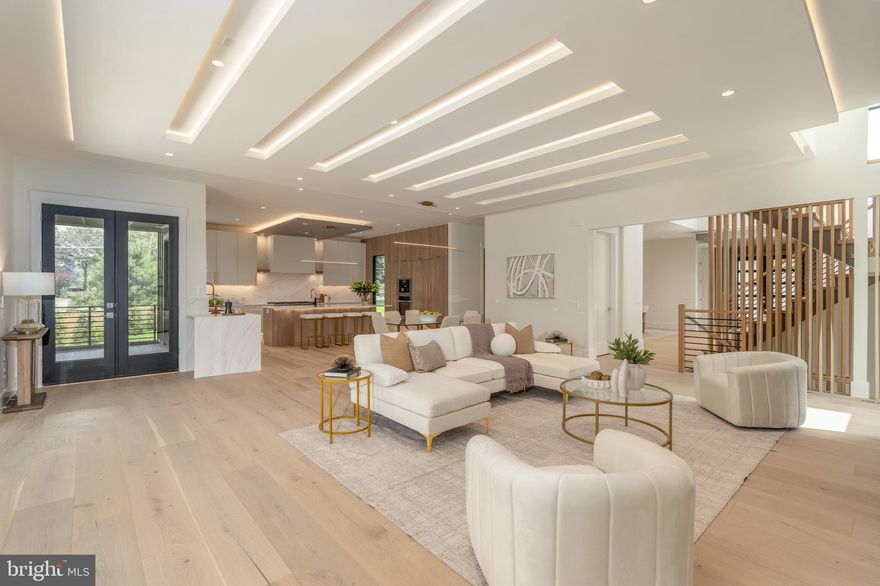 Experience elevated living in this luxury new construction architectural gem—where thoughtful design, luxury finishes, and a prime location just steps from Westwood Country Club come together seamlessly. Designed with entertaining in mind, this home offers the perfect setting for hosting everything from large celebrations to intimate gatherings with ease and elegance.
A dramatic two-story foyer welcomes you into over 7,450 square feet of artfully crafted living space featuring 7 bedrooms and 6.5 bathrooms. The open floor plan flows effortlessly through formal and informal living areas, highlighted by 10-foot ceilings, expansive picture windows, and warm wide-plank hardwood floors throughout the main level. The chef’s kitchen is a true showstopper—complete with a 9-foot center island. For easy everyday living there is a supplemental culinary food prep with a large sink, serving counter, built-in cabinetry and a second dishwasher. Miele appliances, a 60-inch side by side refrigerator, a built-in plumbed coffee station, and a separate butler’s pantry, all beautifully designed for everyday living and effortless entertaining.
The family room features a sleek ceiling design with integrated tape lighting, a linear gas fireplace with passive heat flow, and a wall of windows that open to a massive deck with a trellis-style ceiling and shades—creating a seamless indoor-outdoor experience for guests. There is also a screened porch which is accessible from the kitchen, family room and the deck.  Round out the main level is a secondary suite that can be used as an office or bedroom, adding to the versatility of the home's layout. Completing the main level is a spacious three-car tandem garage equipped with two EV charging outlets.
The open staircase, detailed with custom Poplar wood partitions, is a design centerpiece leading to the second level where you are greeted by a spacious informal living area. The primary suite is a luxurious retreat featuring its own heating and cooling system, two walk-in closets, a spa-inspired bath, and a private sitting room with fireplace—ideal for ideal mornings or unwinding at the end of the day.  Three additional spacious bedrooms each with its own bathroom and ample closet, and one with balcony for outdoor enjoyment.
The sprawling lower level features a stunning recreation area with a wet bar and a media room. Additionally, there are two flexible rooms that can serve as bedrooms or an exercise space, along with a full bath. French doors provide access to a covered patio, ensuring privacy and comfort for guests or multigenerational living.
Situated in a new, private six-home cul-de-sac with no HOA, across from the golf course —walkable to shops, Whole Foods, restaurants, and coffee spots, bike path, and minutes from Tysons Corner and Metro access. With standout design and a layout built for entertaining, this home delivers an unmatched lifestyle in one of Vienna’s most desirable locations.