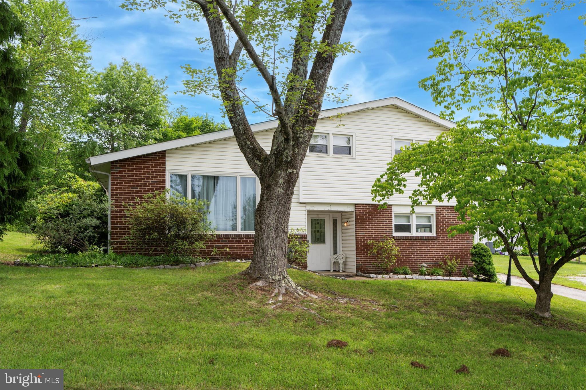 This charming 3-bedroom, 2.5-bath split-level home is nestled on a spacious corner lot in the highly sought-after Colonial School District. Step inside to find a bright and airy layout featuring hardwood floors, vaulted ceilings in the living room, and a generous dining area with sliders that lead to your own backyard retreat.
The kitchen is updated with white cabinetry, granite countertops, stainless steel appliances, and a cozy breakfast nook. Upstairs, you'll find three well-sized bedrooms and two full bathrooms, including a beautifully renovated walk-in shower.
Step outside to discover your private oasis — a large in-ground pool with ample patio space, the pool and patio area is fenced in with mature landscaping for privacy. Whether you're hosting summer BBQs or enjoying a peaceful evening swim, this backyard is made for relaxing.