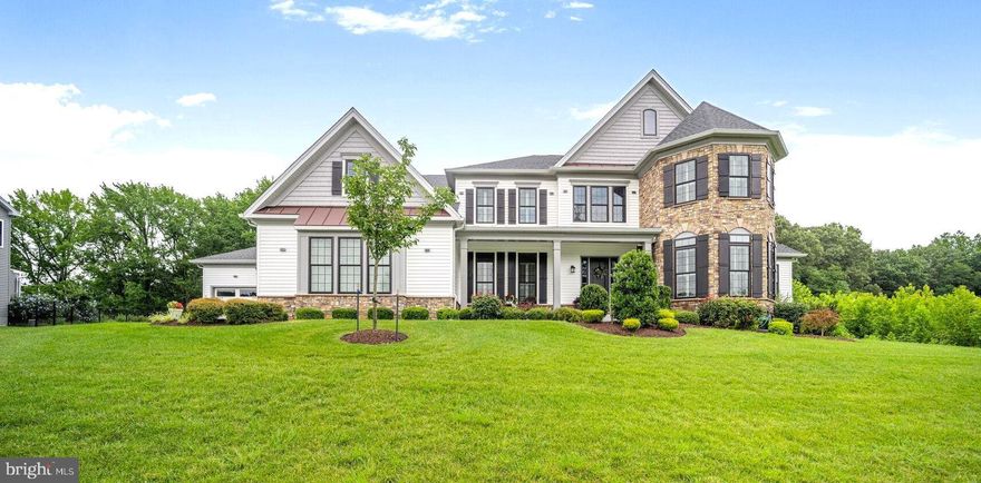 This is the one you’ve been waiting for . . . an extraordinary 9,485 sq ft custom modern farmhouse, perfectly positioned at the end of a private drive and bordered by 55 acres of protected forest restoration land. Situated on nearly half an acre, this 5 bedroom, 5.5 bath estate offers unmatched privacy, luxury, and space across three expansive levels.
A dramatic two-story foyer with custom architectural wall paneling and a dual staircase sets a grand tone upon entry. The main level showcases a 1,000 sq ft custom in-law suite with a sitting area, private bedroom, spa-inspired bath, and an enviable walk-in closet with built-in storage for 77 pairs of shoes. Entertain in style in the formal dining room with tray ceiling and designer lighting, or unwind in the open-concept family room featuring a striking stone fireplace and access to the expansive Trex deck overlooking serene woodlands.
The gourmet eat-in kitchen is outfitted with high-end granite countertops, stainless steel appliances, a spacious pantry, and a large dining area. A 3-panel pocket door opens to a screened porch with motorized screens, seamlessly connecting indoor and outdoor living. Off the kitchen, a mudroom adds convenience and functionality.
The upper level features a serene primary suite with a sitting area, custom wood tray ceiling and a spa-quality bath complete with a frameless glass shower, soaking tub, dual vanities and two large custom closets, plus 4 additional spacious bedrooms, an en-suite and a Jack-and-Jill bath.
The finished walk-out lower level offers endless possibilities—ideal for a home theater, office, gym, or game room—with ample storage and built-in shelving.  A spacious four-car garage provides room for vehicles and hobbies.
Additional upgrades include Arhaus designer chandeliers, ceiling fans in every room for year-round comfort, and premium finishes throughout.
This exceptional home offers a rare blend of elegance, versatility, and peaceful seclusion—just minutes from shopping, dining and commuter routes.