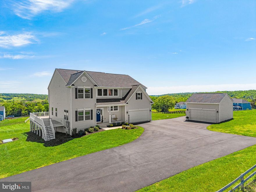 3039 Clearview Farm Lane presents a rare opportunity to own a beautifully appointed 6-bedroom, 5.5-bath residence on 6.81 scenic acres in Warrenton. Newly constructed just over a year ago, this exceptional home captures breathtaking 360-degree mountain and pastoral views while offering the convenience of being just minutes from historic Old Town Warrenton, local farm markets, breweries, &  wineries. Designed for both elegant everyday living & effortless entertaining, the home features an open floor plan, an airy foyer, & a striking hardwood staircase that leads to the upper-level breezeway. The main level includes a highly desirable, soundproofed primary suite, a flexible office or sitting room, and a cozy gas fireplace with fireproof insulation. Expansive windows & sliding glass doors flood the kitchen and sunroom w/ natural light while framing sweeping views in every direction. The kitchen is beautifully finished w/ granite countertops, oversized island, a 5-burner gas range, abundant cabinetry, & generous seating for gathering w/ family & guests., 32 Levolor cordless wood blinds enhance both comfort & style, vertical blinds on the sliding glass doors. Eleven motorized tilt blinds on the main level, operated by two remote controls, provide added convenience. Just beyond, the 540-square-foot wraparound TimberTech composite deck extends the living space outdoors, creating a remarkable setting for entertaining, relaxing, & taking in everything from rolling summer storms to star-filled skies. The main level also offers a spacious pantry, a practical mudroom near the garage entrance, & a fully insulated attached garage w/ double-ceiling insulation for added sound reduction and temperature control.Upstairs, four generously sized bedrooms include a second expansive primary suite w/a full-length walk-through closet & a luxurious bath featuring a soaking tub, walk-in shower, dual vanities, & a private water closet. A nearby secondary bedroom enjoys its own private full bath &  walk-in closet, while two additional bedrooms share a spacious full bath w/ a double vanity. Laundry is conveniently located on the upper level. The lower level adds even more versatility w/a large additional bedroom, full bath, abundant storage, & plumbing for a future wet bar. With surround sound prewired for five ceiling speakers and a subwoofer, the space offers excellent potential for recreation, media, or guest accommodations. Additional features include 2025 whole-home Generac generator w/first-year maintenance  a 10-year warranty, an attached 2-car garage with extra R-15 insulation and EV wiring, and a detached oversized 2-car garage that is fully insulated & fully electric. The attached garage is also equipped with plumbing & venting for a stackable washer and dryer. Paved asphalt driveway extensions provide easy turnarounds & additional parking .Five Cat 6 data ports behind five TV locations provide option for high-speed hardwired network connectivity to streaming TVs. An 8-port gigabit network switch is installed in the network panel. Long conduit was also run to the attic pre-drywall. 
Starlink use currently w/ speeds supporting all TVs streaming  at once & ability to work remote using high speed platforms. Solar conduit rough for option to add solar panels in the future. Metal flex conduit w/ pull string from attic to electrical main panel. Junction boxes provided. Additional upgrades include pre-drywall insulation in every interior wall, closets, basement ceiling, attached garage sides and second ceiling, and alcove spaces in upper level bonus room.Dual whole-house water filters; a high-output well pump; security system prewiring by Trinity Wiring; also prewired Cat Cable Networking.Leaf Filter whole house gutter guards w/warranty. Extended Elite high-end 2-10 Home Buyers wall to wall  warranty in effect thru 4/2027 transferable to buyer. NO HOA. The seller welcomes all thoughtful offers and is open to considering terms that reflect current market