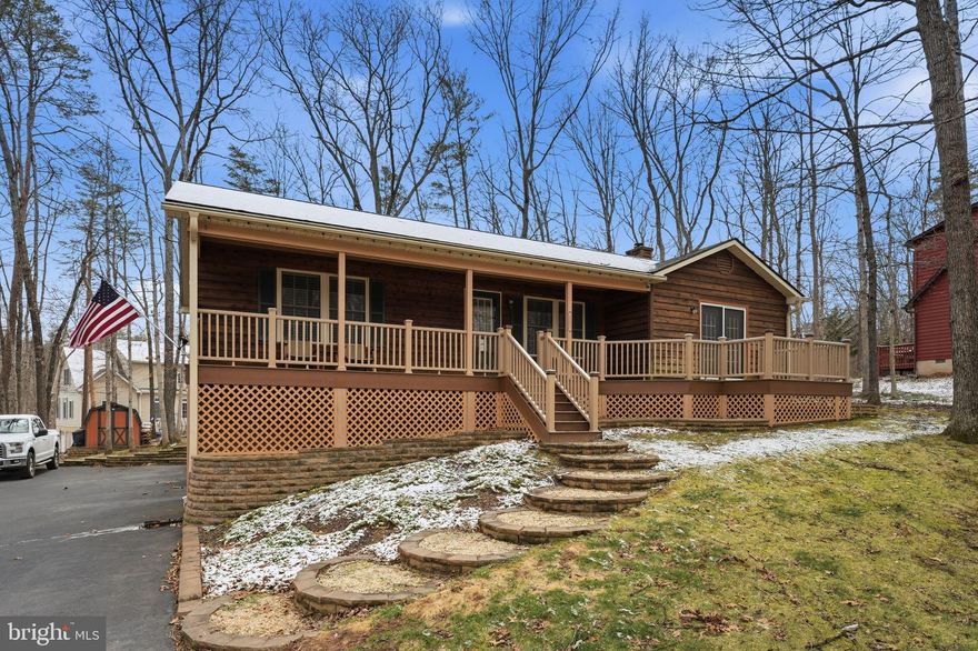 A true show-stopper from the road, this immaculately maintained cedar rancher offers stunning curb appeal and exceptional living inside and out! Nestled on a level wooded lot in the gated community of Lake Holiday, this beautiful cedar and stone home combines comfort, style, and thoughtful updates throughout.
Relax on the inviting front porch or entertain guests on the expansive rear deck—both finished with low-maintenance Trex decking. Inside, the open-concept living, dining, and kitchen area offers flexibility for today’s lifestyle and is filled with natural light. The well-equipped eat-in kitchen features stainless steel appliances, Corian countertops, and French doors leading to the rear deck—perfect for indoor-outdoor entertaining.
The spacious primary suite and second bedroom both include walk-in closets, while the home has been meticulously updated with a newer roof, HVAC system, hardwood flooring, and beautifully custom-tiled bathrooms.
The finished lower level is designed for both comfort and function, offering extensive custom built-in cabinetry, a bar area, and a cozy brick wood-burning fireplace—ideal for relaxing on cool evenings. With a full bath and laundry area, the lower level also provides excellent potential for an in-law suite or extended guest space.
An oversized two-car garage features custom modular flooring that conveys with the sale.
Enjoy the best of lake living with all the amenities Lake Holiday has to offer—boating, fishing, swimming at two sandy beaches, a fishing pier, clubhouse with fitness room, volleyball, tennis, pickleball and basketball courts, walking trails, and playgrounds—all within a peaceful community just 20 minutes from Winchester.
Bring your boat and start enjoying life where every day feels like a vacation!